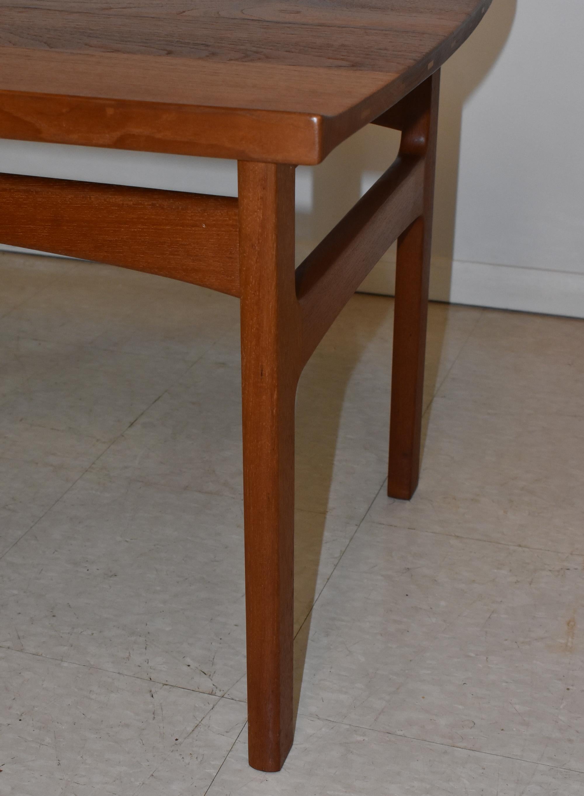 Danish modern teak side table Edvard Kindt Larsen Saffle design. Curled inlay edge. Signed on the bottom. Very good to excellent condition. Dimensions: 22