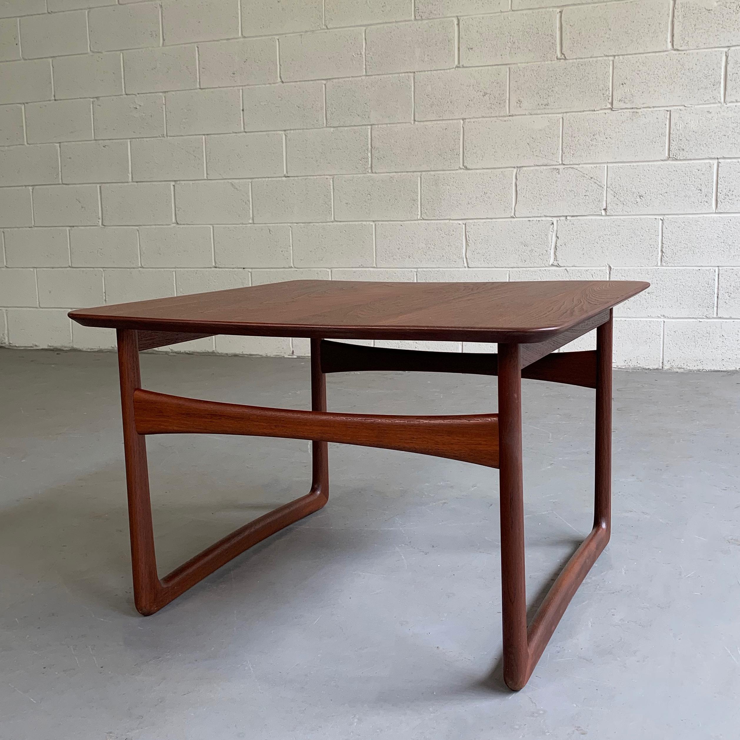 Elegant, Mid-Century Modern, teak, side table by Peter Hvidt & Orla Mølgaard-Nielsen sold by John Stuart features sleigh legs that are interesting from all angles. Two tables are available.