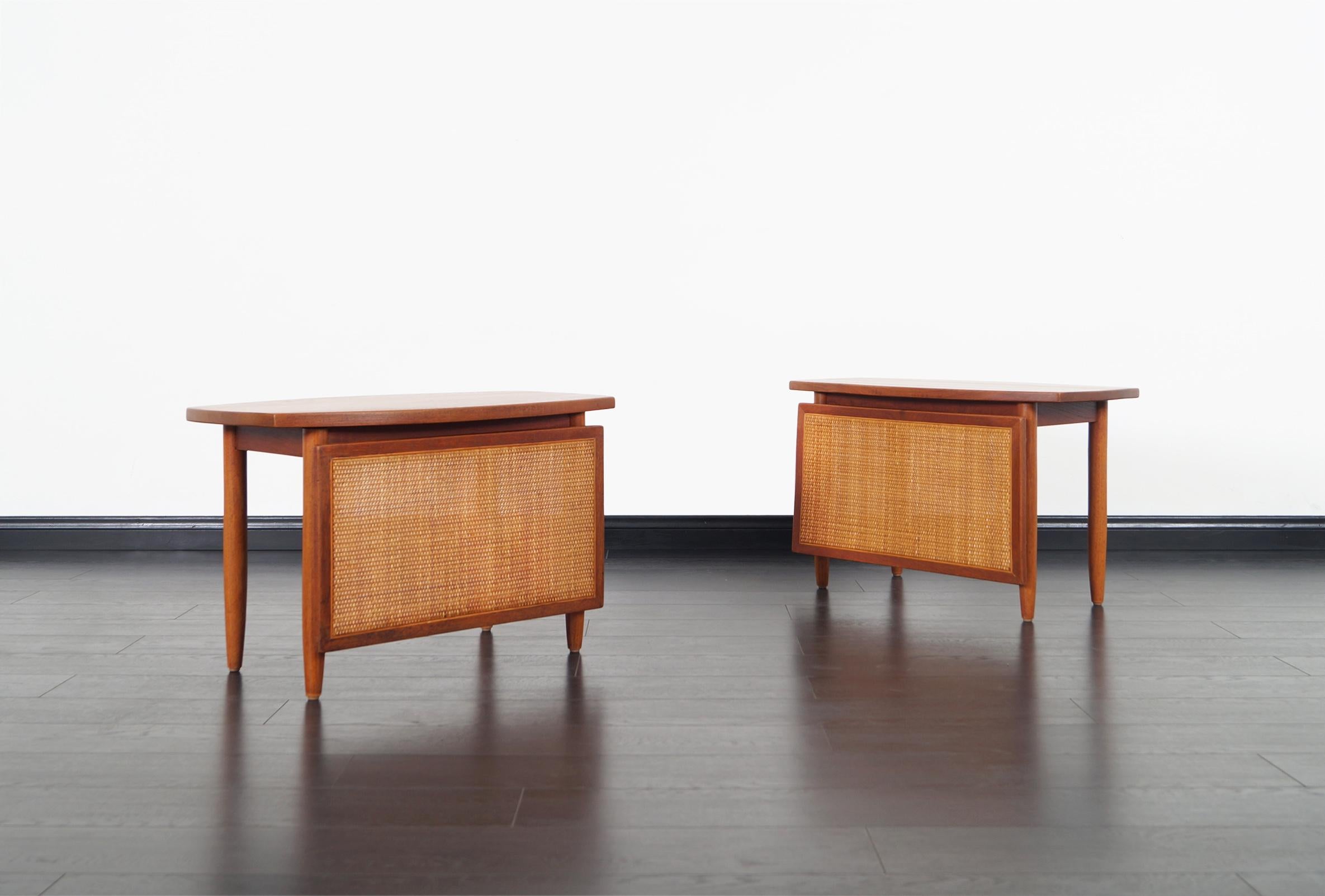 Fabulous pair of Danish modern teak side tables by Peter Hvidt and Mølgaard-Nielsen for Søborg Møbelfabrik. Crafted from solid teak with woven cane panel.