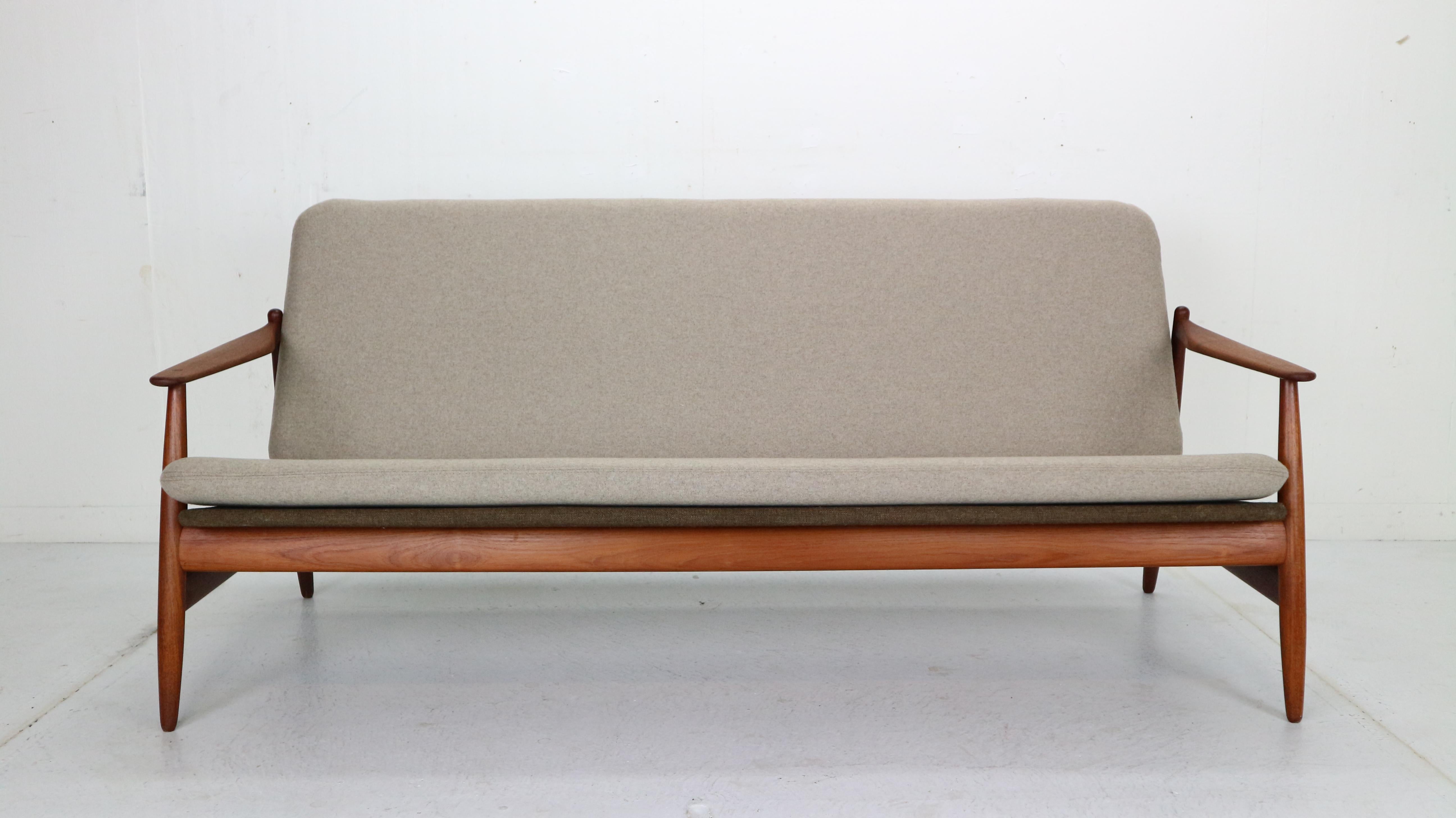 Danish modern period sofa made in 1960's by Poul M. Volther and manufactured by Frem Rojle, Denmark.
Elegantly curved teak frame and two colour seating witch has been newly reupholstered in a wool fabric. Three colour combination makes the sofa