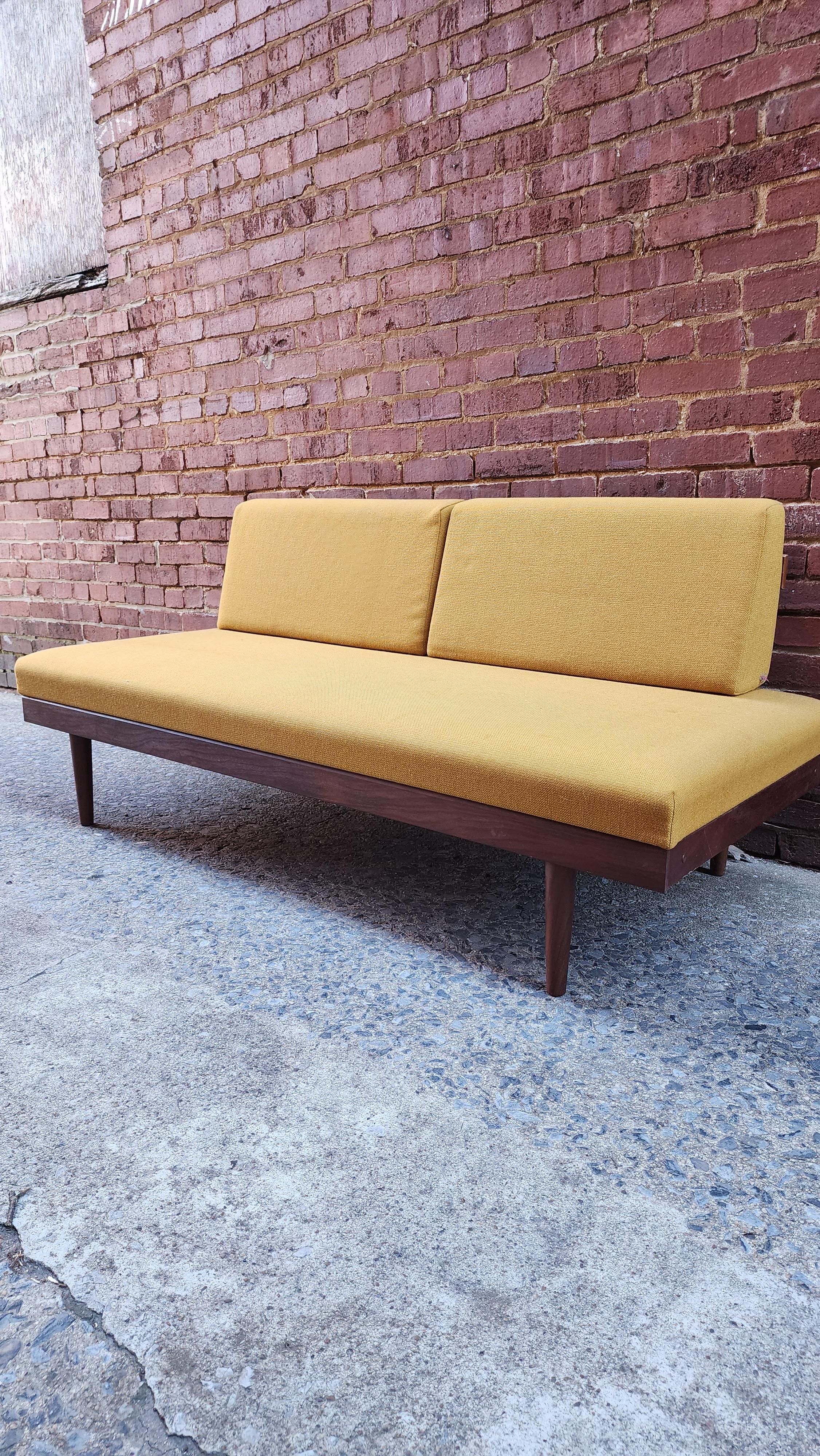 This Danish teak sofa has a secret. It has hide-away side tables but even better, it opens up into a very comfy bed. One of the most clever designs of the 50s, these are are in very good original condition. Some slight staining on fabric. See