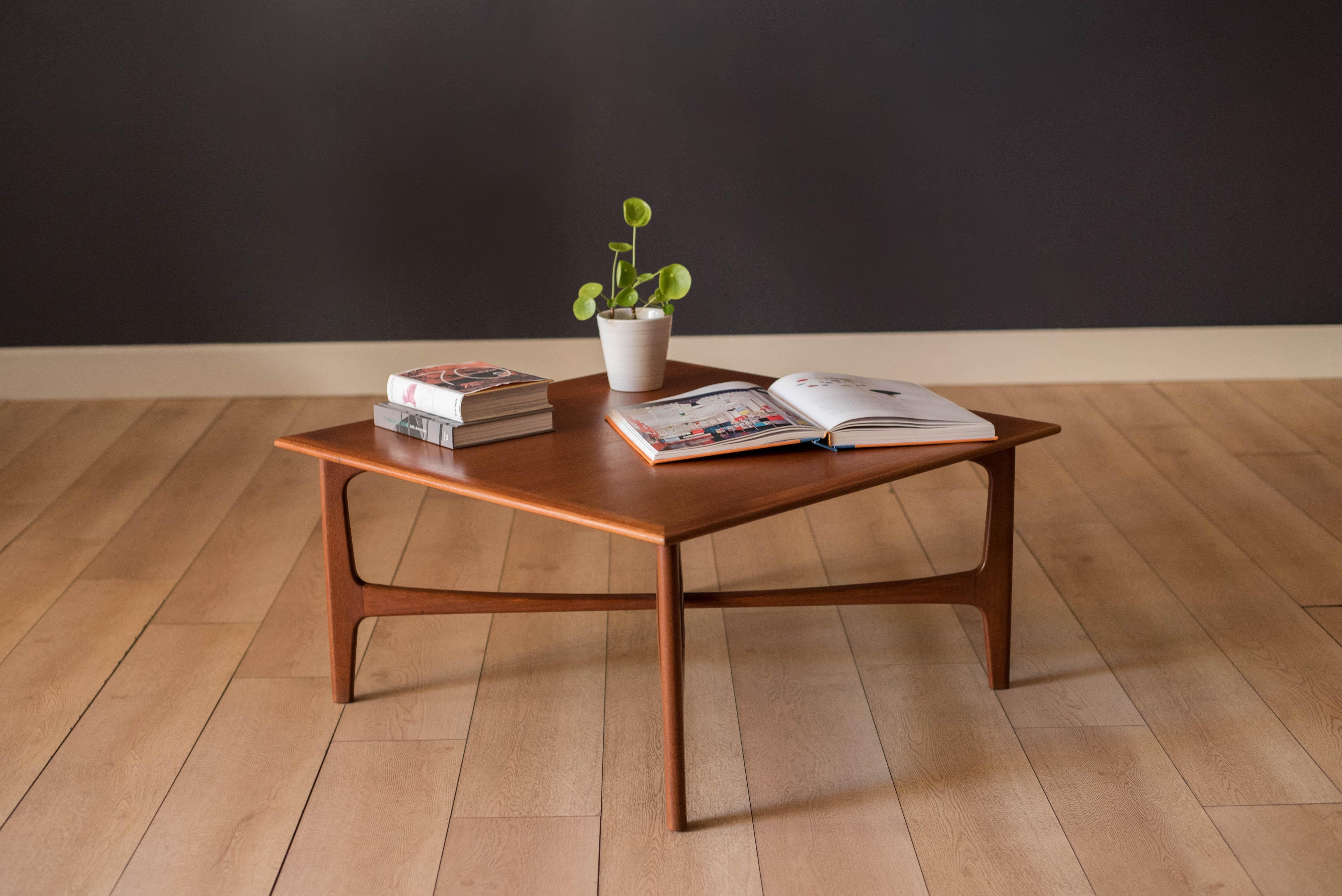 Mid century modern coffee table in teak designed by Folke Ohlsson for Dux, circa 1960's. This piece features a sculptural supporting x- base and can also function as an occasional table or living room side table. 





Offered by Mid Century Maddist