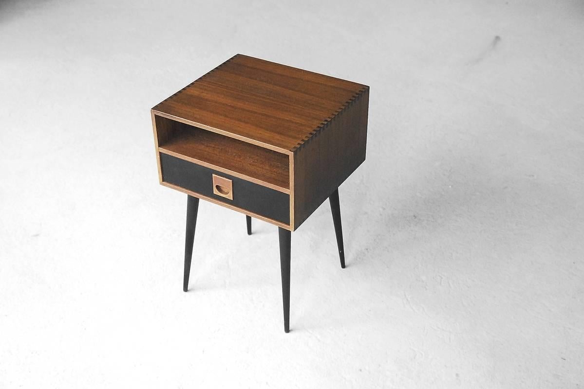 This small table was manufactured in Denmark during the 1960s. It is made from teak and has a drawer with a teak handle. The drawer has been upholstered inside. It remains in perfect original condition.
