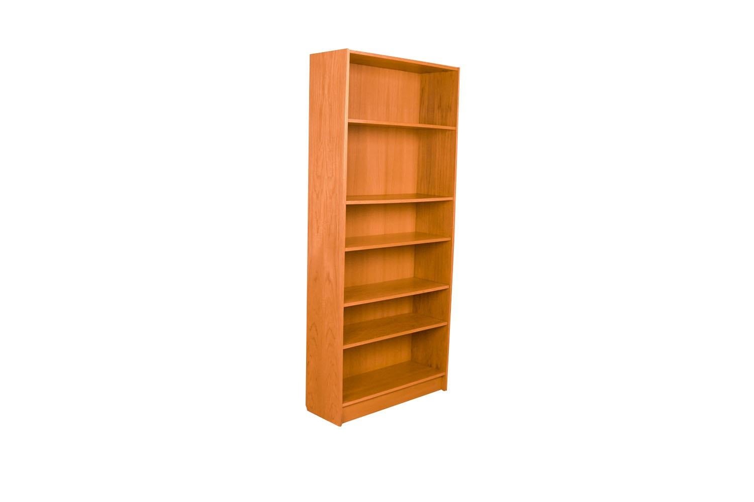 An exceptional teak tall bookcase from Denmark. Gorgeous Mid-Century Modern Teak bookcase / tall bookshelf unit. Beautiful, minimalist, clean, straight lines, features 4 adjustable shelves and one fixed for various display configurations. Tall and