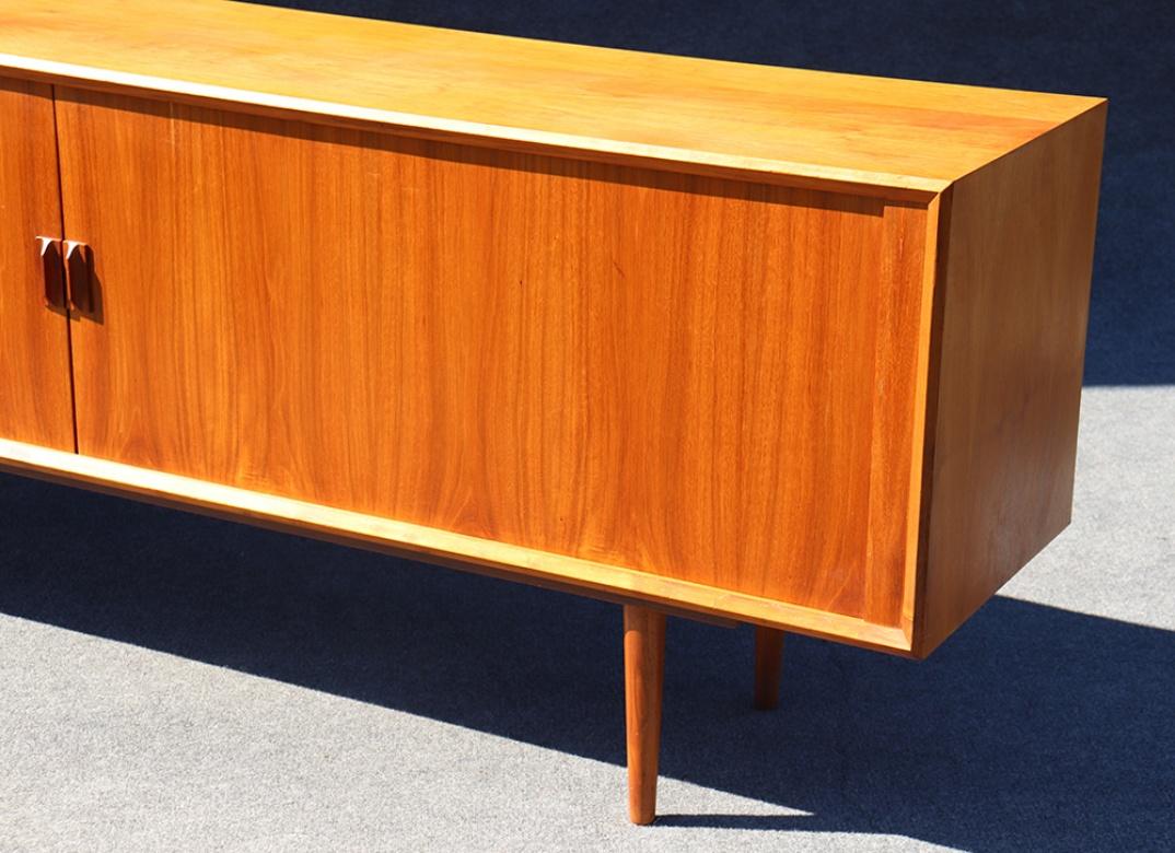 This is a gorgeous teak sideboard with tambour doors that open smoothly and easily, the way only the Danish could make them do. The fit and finish on this piece is absolutely excellent with few signs of use and is so beautifully design and sleek.