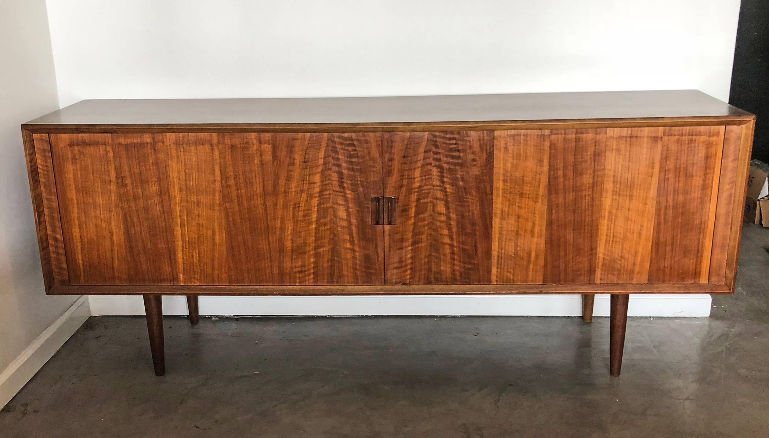 Svend Larsen for Faarup Mobelfabrik Danish modern teak credenza. This super long credenza is just as breathtakingly beautiful on it back as it is its front, featuring a fully finished back so it can be floated within a room.

At 79.75