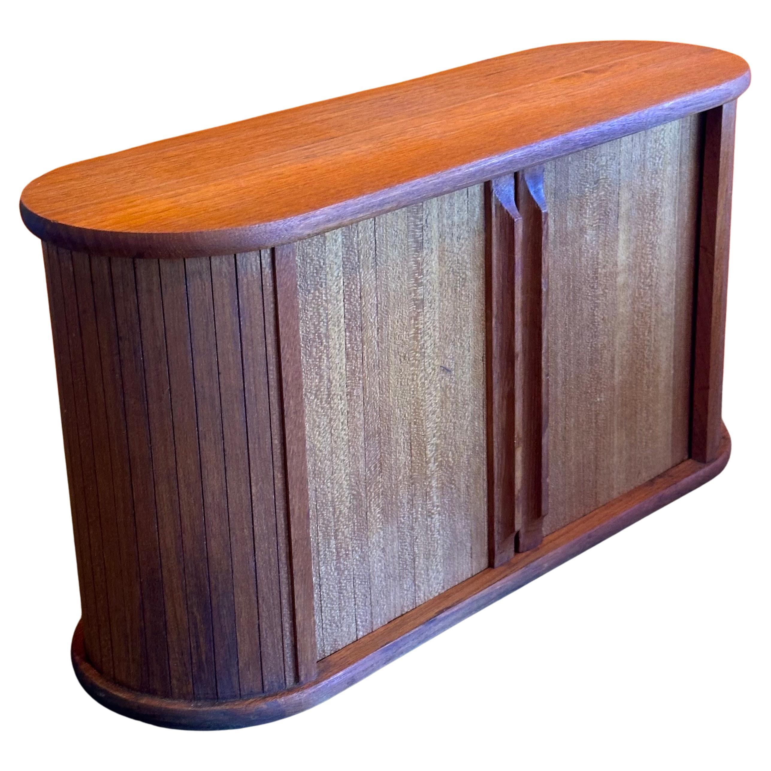 Danish modern teak tambour door hanging storage cabinet, circa 1970s.  This beautiful well crafted box can be hung on a wall or used on a desk top.  The piece is in very good vintage condition and measures 18