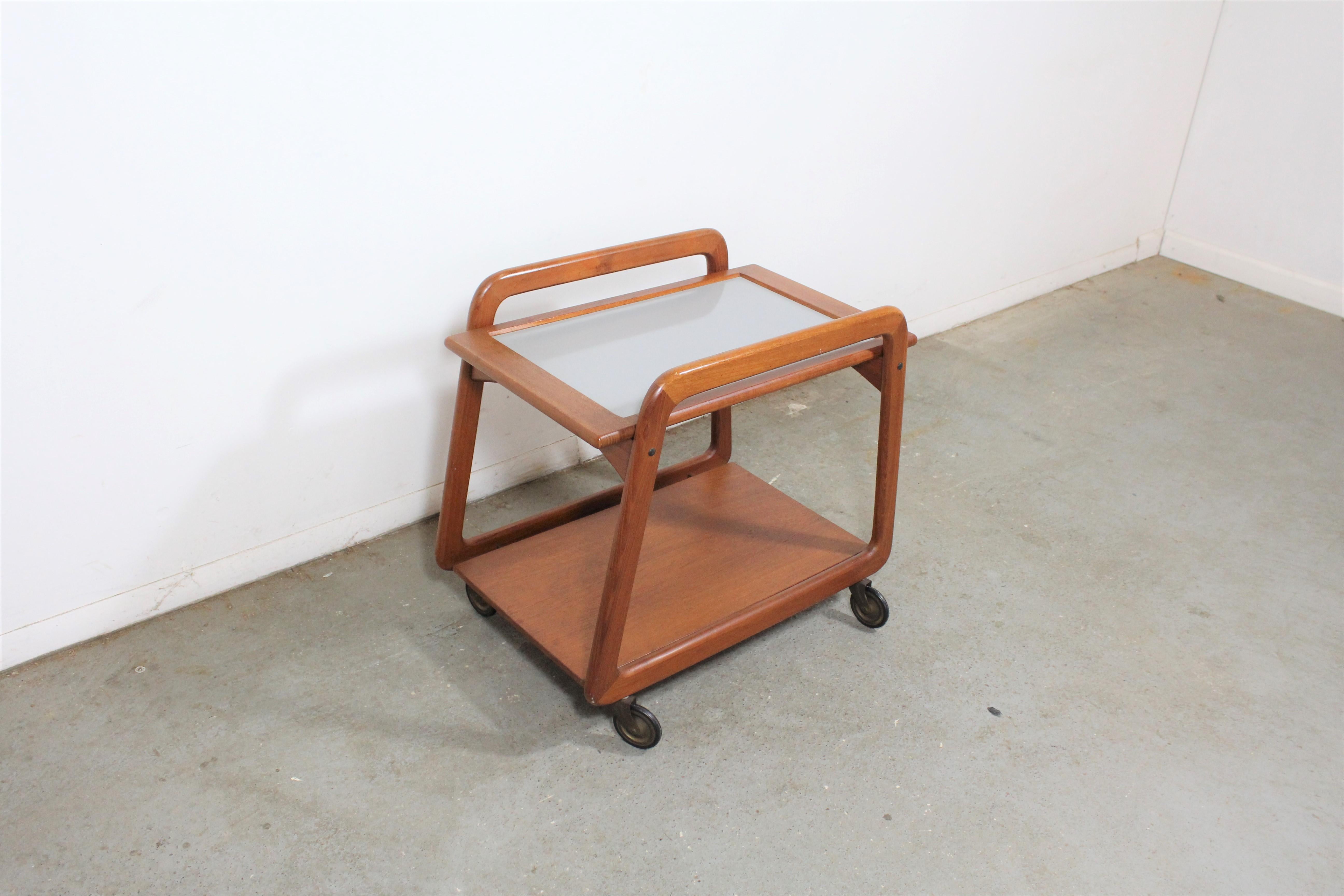 Danish modern teak tea bar/cart.

Offered is a vintage Danish modern bar cart on wheels. Great for storage, serving drinks, or food. It is in good vintage condition, showing some age wear (minor surface wear/scratches, age wear--see pictures). It