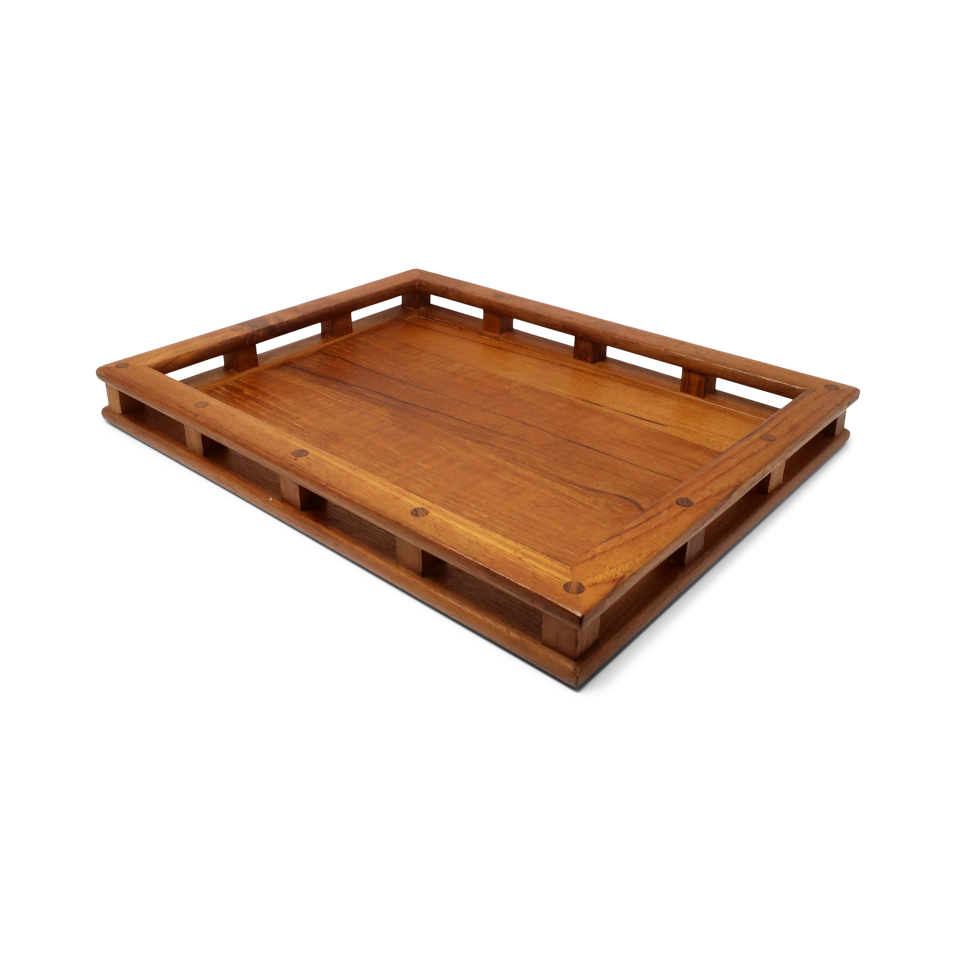 A Mid-Century Modern Dansk teak tray that is perfect for breakfast in bed, working on your laptop, dinner on the couch, or serving drinks to your favorite people. 

In good vintage condition with wear consistent with age and use. Marked on