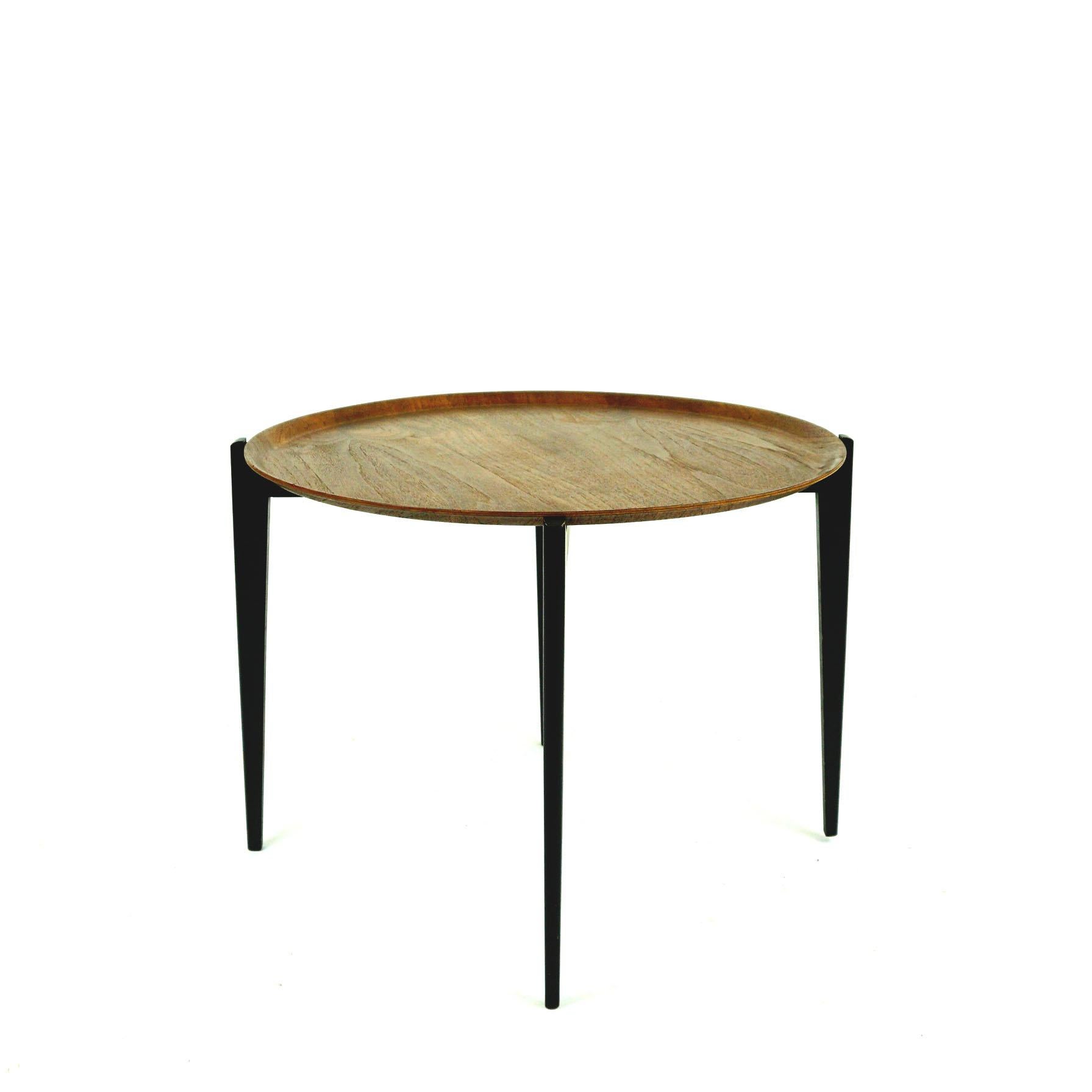 Iconic Scandinavian circular foldable teak side table with removable tray top in the style of Svend Åge Willumsen & Hans Engholm for Fritz Hansen. 
This table was manufactured in the 1950s and is marked two times Made in Sweden, at the foldable