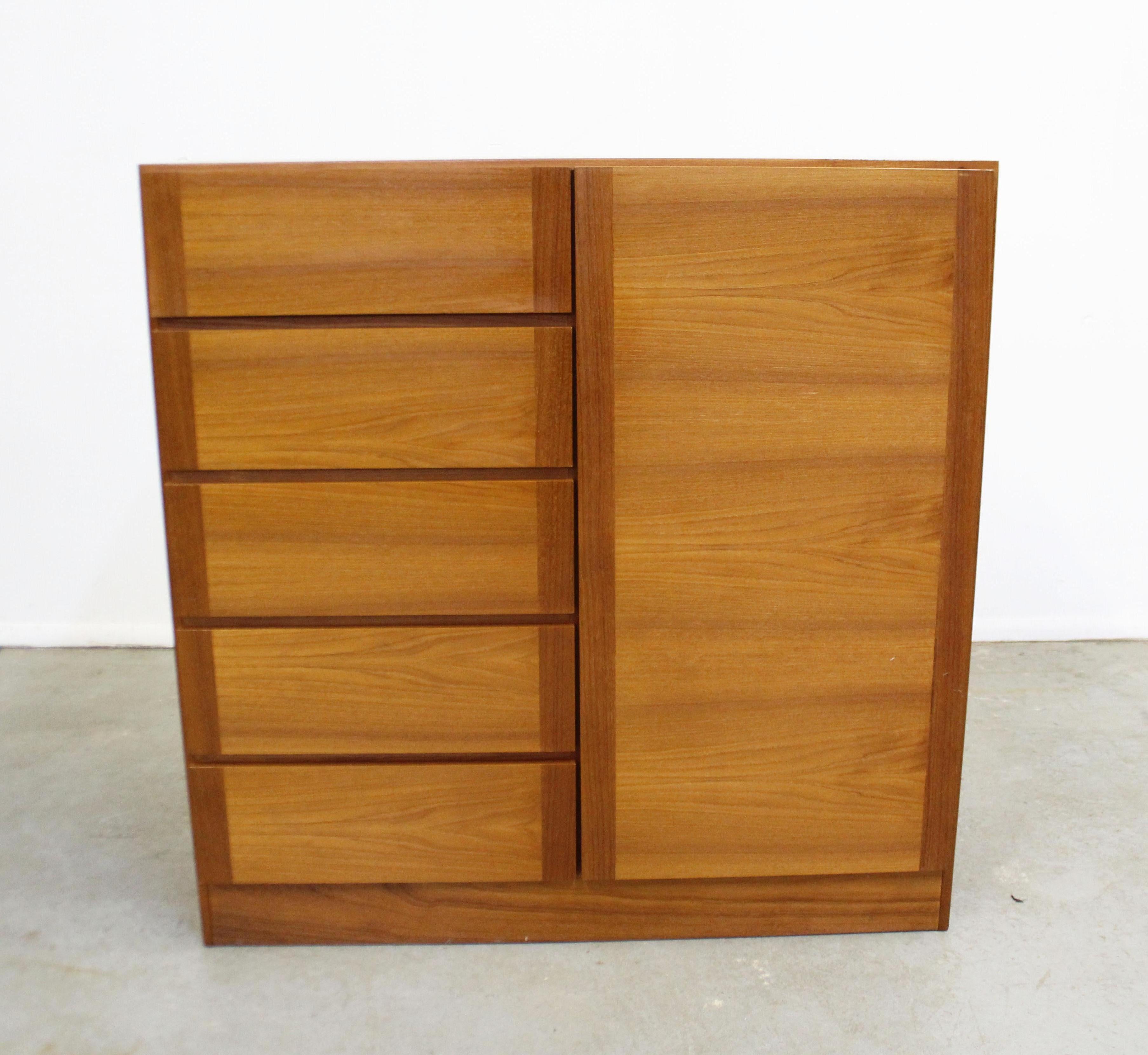 Offered is a Danish modern gentleman's chest by Vinde Mobelfabrik. It's is made with teak and features 5 drawers on one side and shelving on the other. It is in good vintage condition with minor surface scratches/ wear. It is marked by Vinde