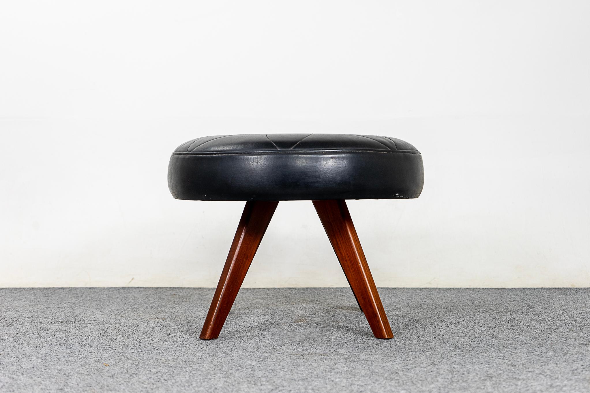 Teak & vinyl Danish footstool, circa 1960's. Compact round design, can be used with virtually any seating type. Decorative quilting on the top, small repair on the side. Put your feet up, you deserve it!

Please inquire for international shipping