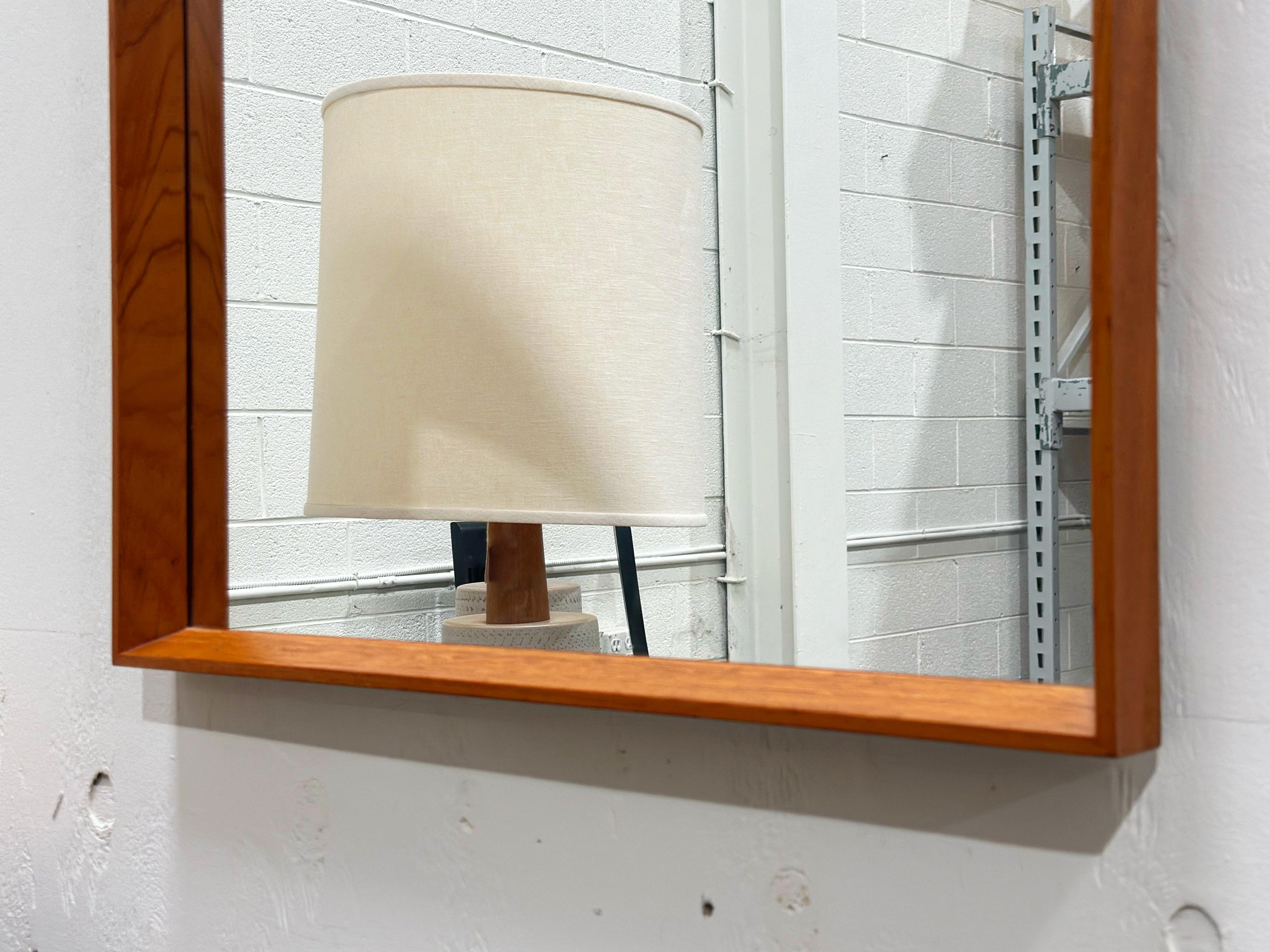Rare teak square hanging wall mirror by Pedersen & Hansen, Denmark circa 1960s. Gorgeous old growth teak wood grain throughout the rectangular frames. Stunning in person. Mirror glass is in excellent condition with no flaws to speak of. Teak frame