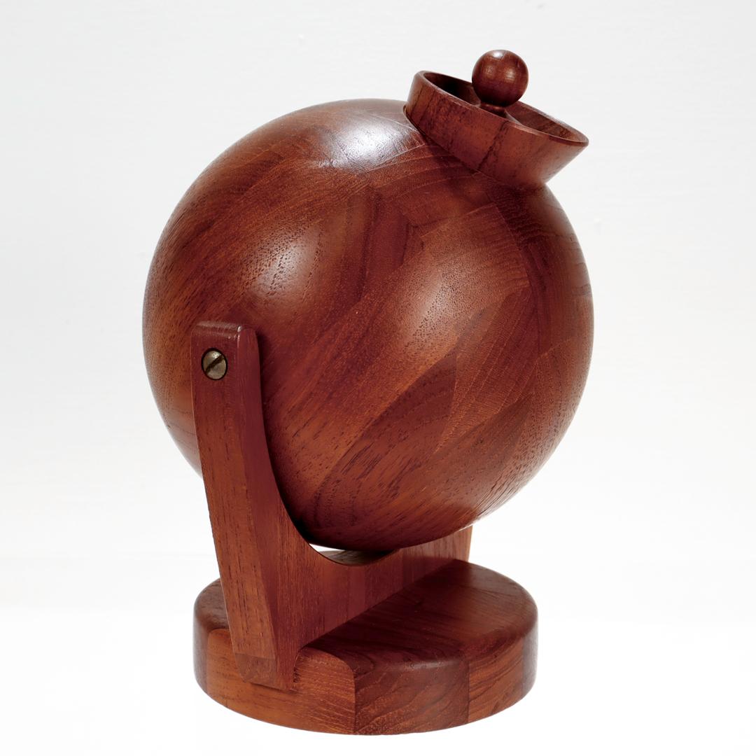 A fine Danish Modern salt ball or container.

In stack laminated teak wood.

Attributed to Erik S. Angelo (ESA).

With a spherical ball or canister bolted toa wall mounted bracket.

Branded to the reverse Denmark.

Simply wonderful modern Danish