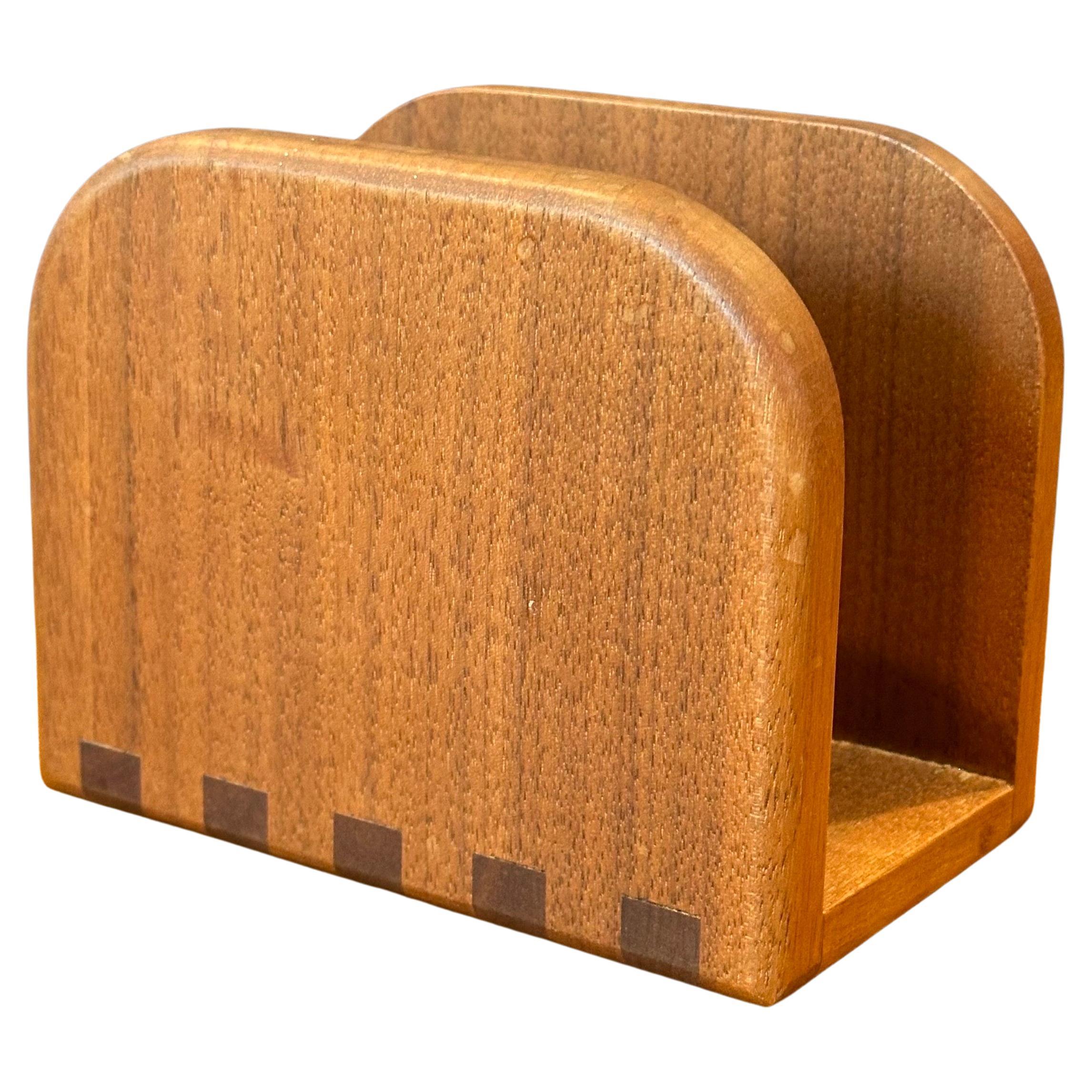 A very cool and unique Danish modern teak and walnut napkin holder, circa 1970s. The piece is in very well crafted, in good vintage condition and measures 5.75