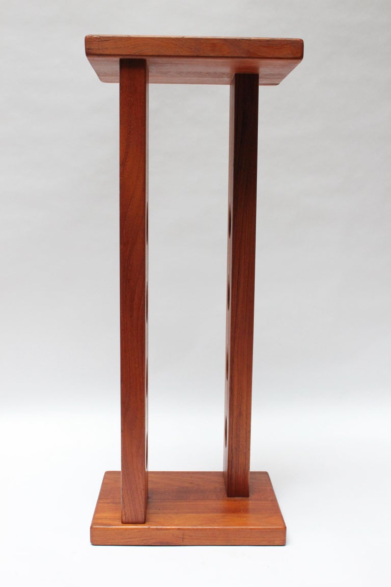 Scarcely seen staved teak table top or floor wine rack designed in the 1960s by Jens Quistgaard for Dansk Designs of Denmark. Holds up to 8 bottles. 
New refinished condition, though light wear remains. 
Measure: H: 26.5