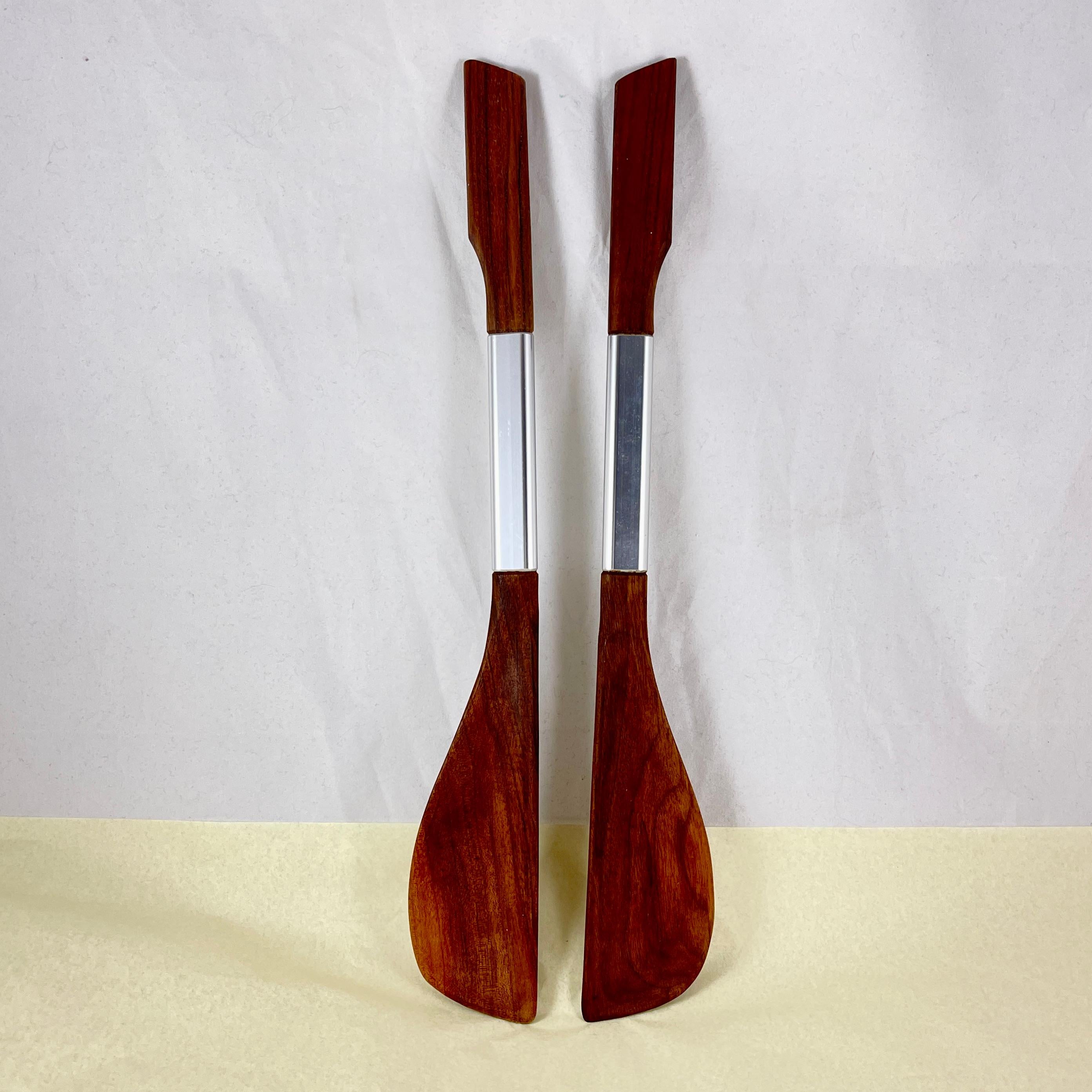 A pair of long handled salad servers of Danish design, from the Scandinavian Modern Mid-Century era, circa 1960-1970.

Carved from teak wood and banded with stainless steel, beautifully balanced.

16 in. L x 2.25 in. W x .50 in. H
Excellent
