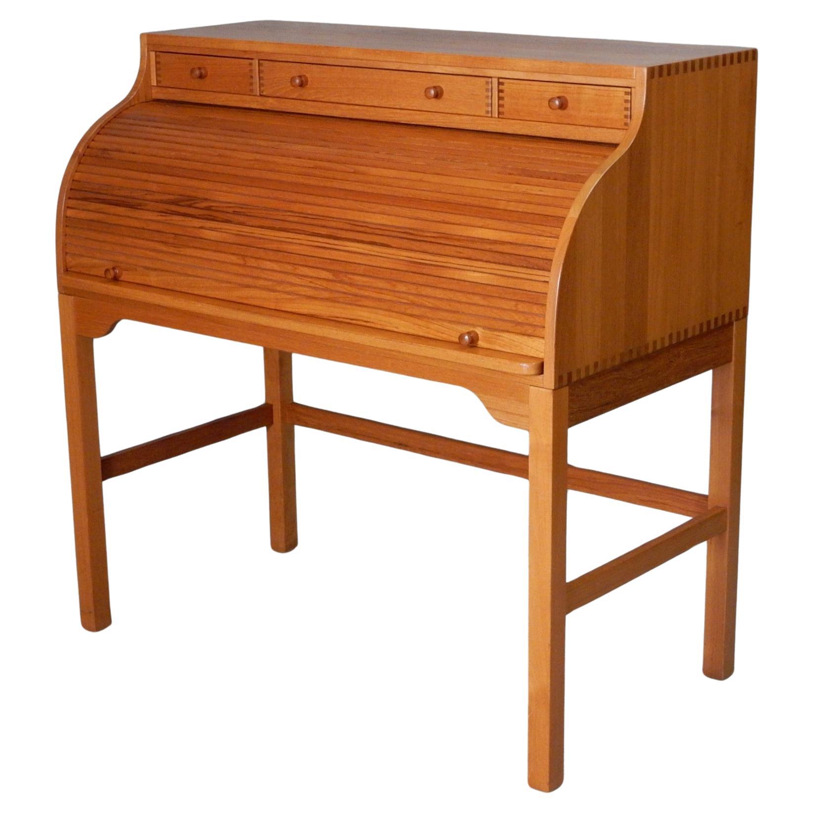 Stunning solid teak writing or letter desk designed by Danish master designer Andreas Hansen.
Circa 1960's, made in Denmark. Pull out leather top writing area, 9 drawers and organization slots with a locking roll top cover (2 keys included). This