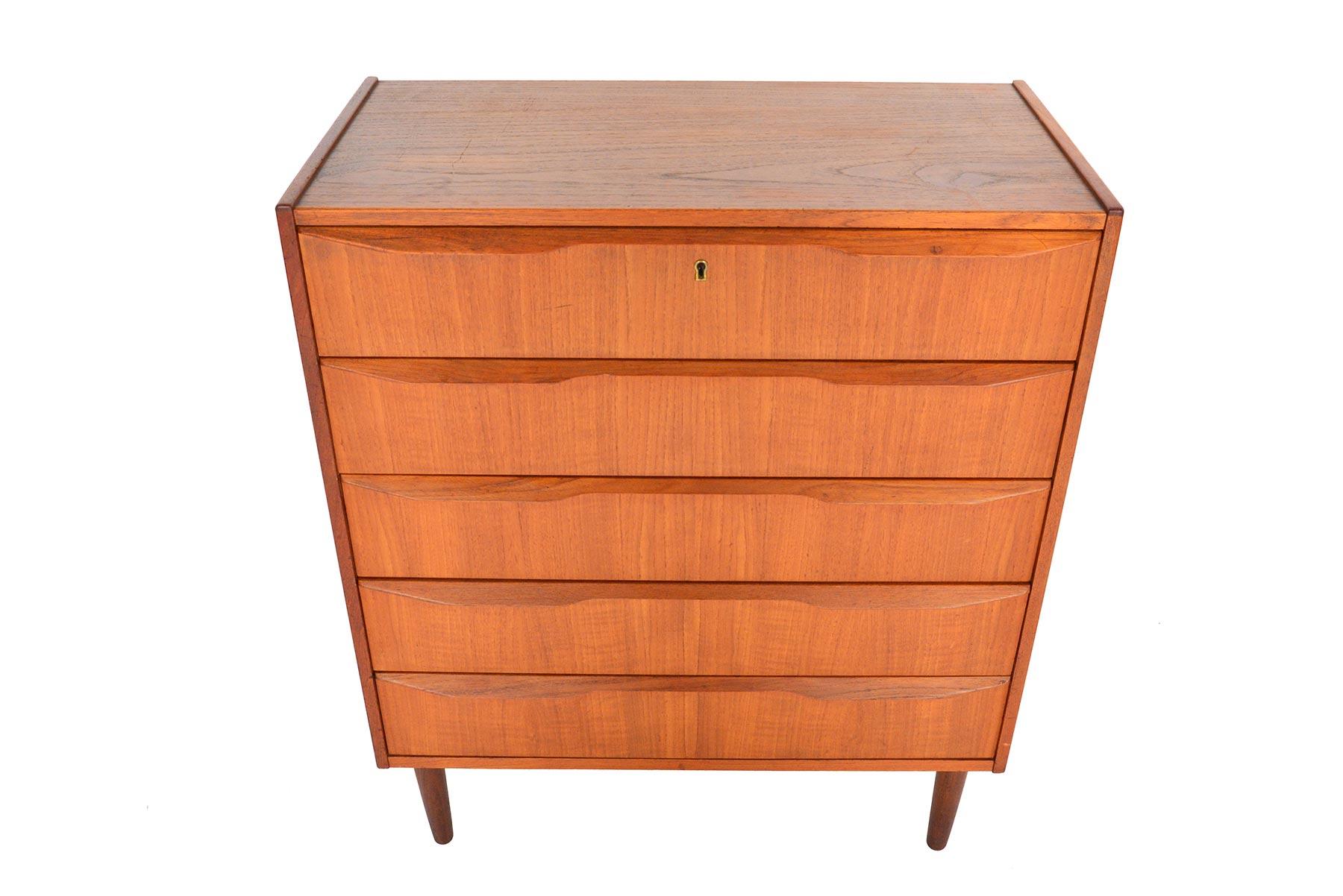 This gorgeous Danish modern five-drawer teak highboy dresser by Tibergaard is a rare find. Rich woodgrain and sculpted quarter- profile pulls define this piece. In excellent original condition with typical wear for its vintage.

 
