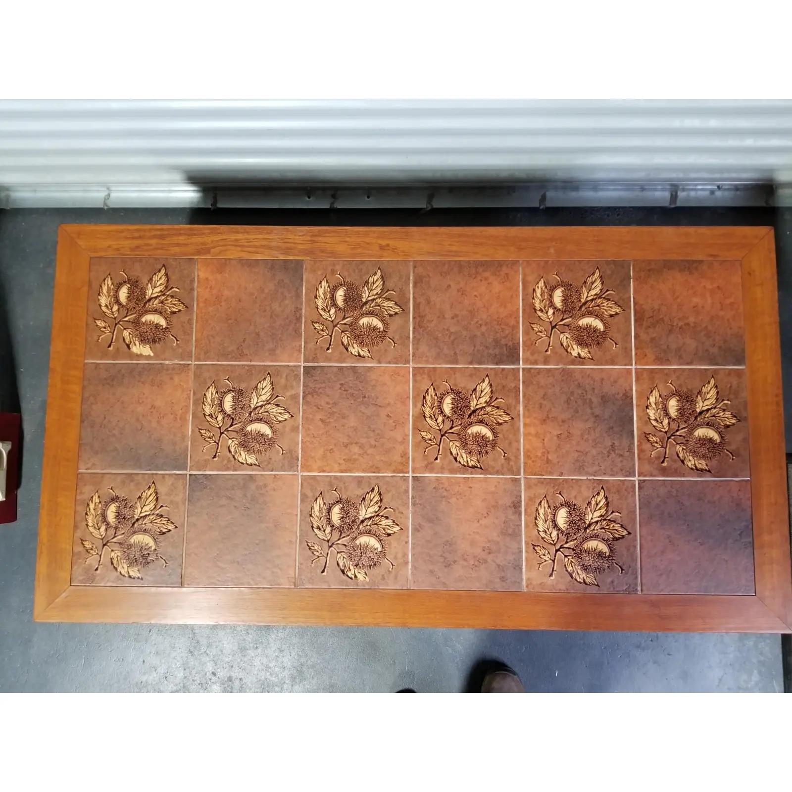 Teak and ceramic tile Danish modern coffee table, circa 1970s. Solid teak legs, apron and frame. Brown and tan floral tiles with a burnt orange / amber glow. Stamped 