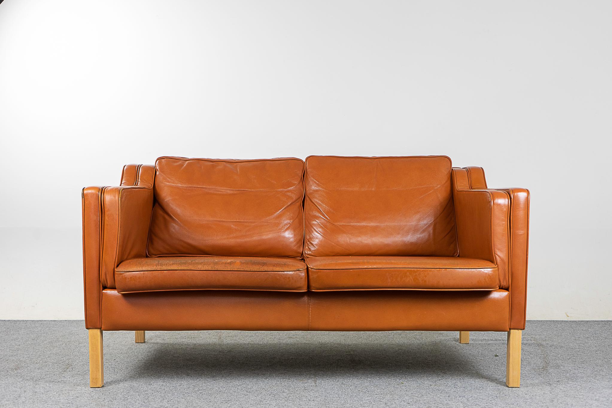 Leather mid-century loveseat, circa 1960's. Original tobacco leather is soft and supple while also being durable to ensure years of use and enjoyment. Very comfortable seats, lined with Stouby fabric. Seats have minor micro scratches.

Please