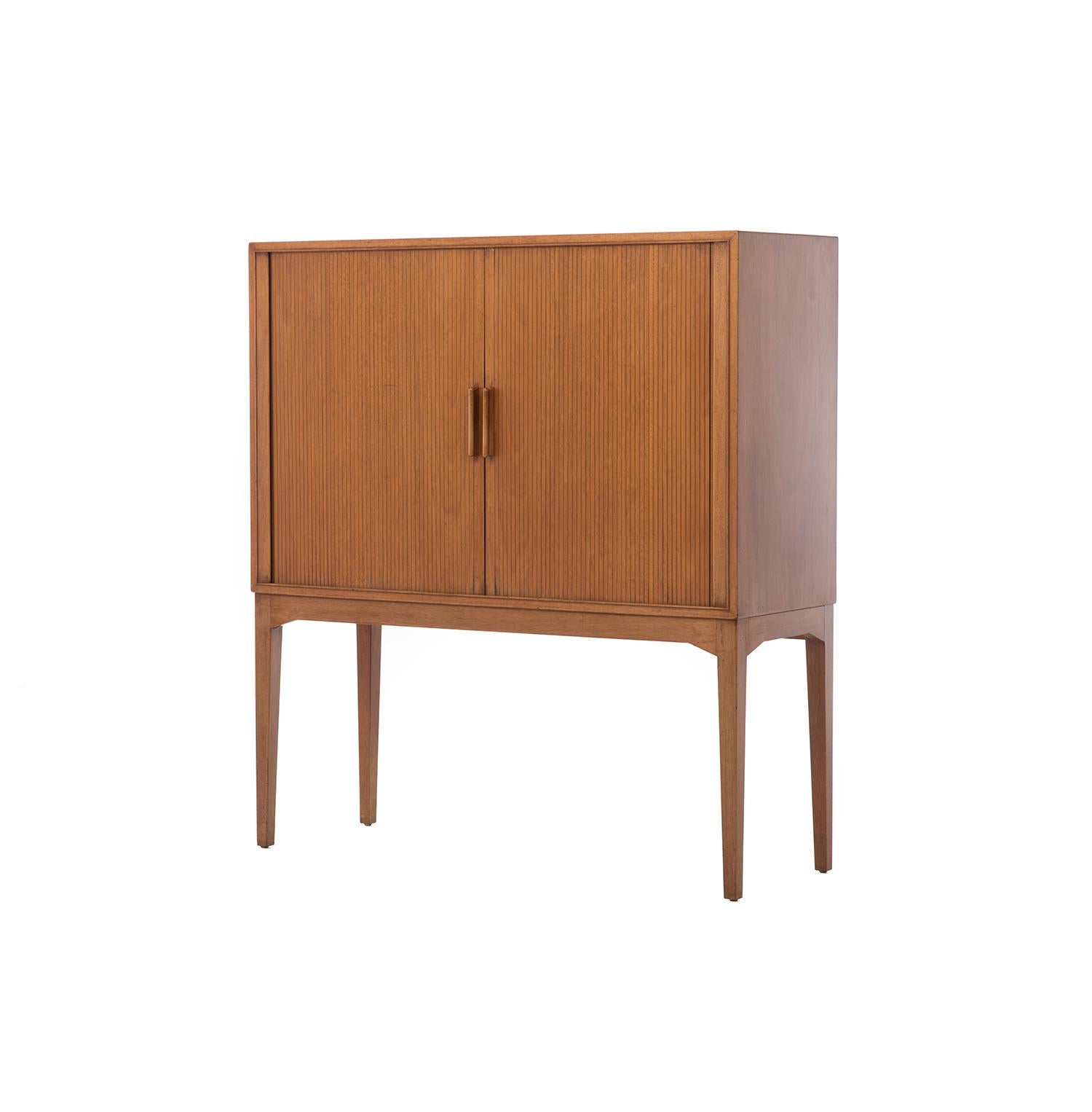 Turn cocktail hour into a ritual and pour yourself a drink over this Danish Modern mahogany bar. Mahogany tambour doors slide open to reveal a stunning European burled birch interior, setting the scene for a perfectly mixed cocktail. This discrete