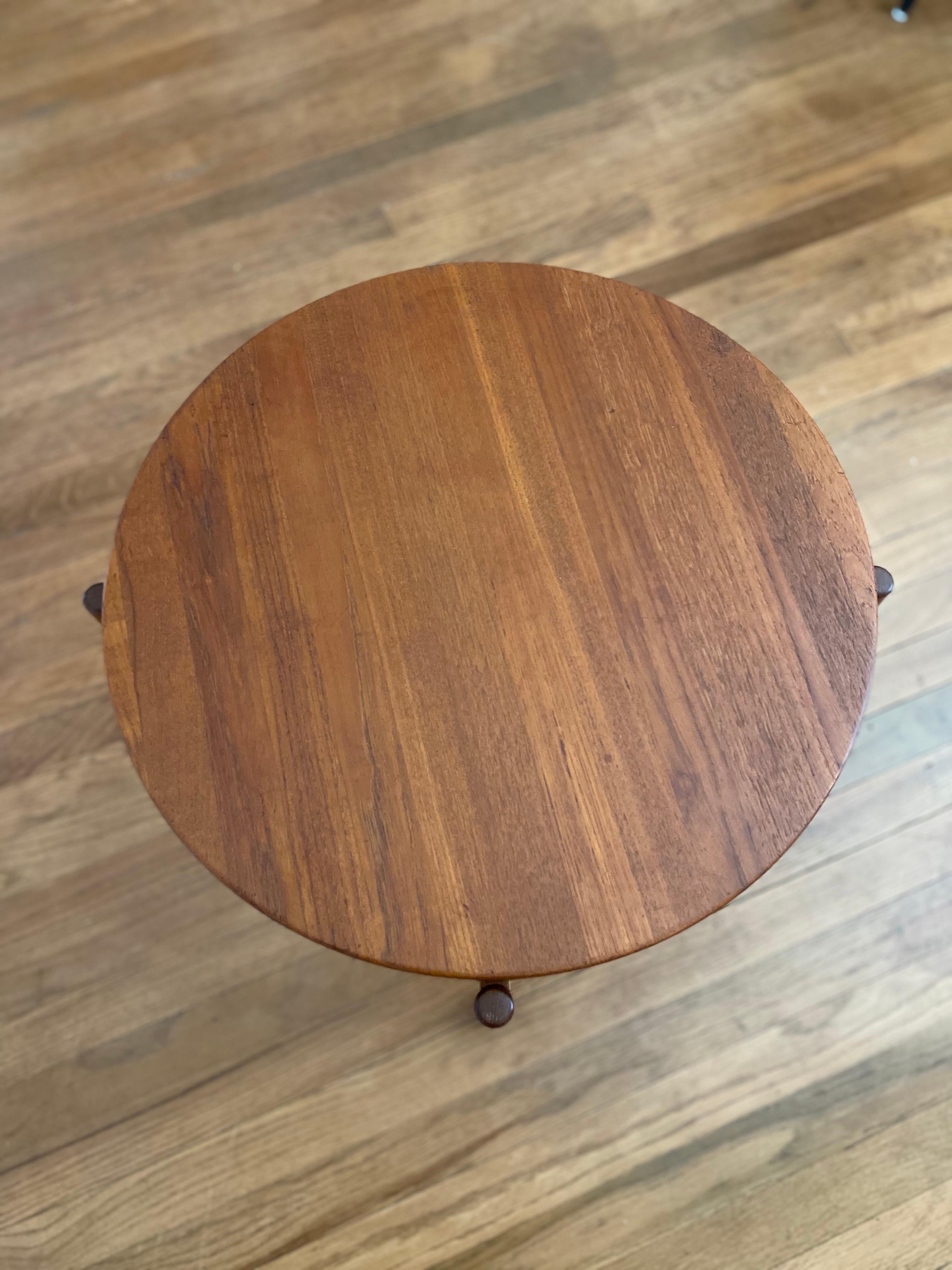 Danish Modern teak side table by Jens Quistgaard, circa 1960s features a removable/reversible top that rests on an X shaped stretcher. This vintage side table or tray is in great condition.

Danish sculptor and industrial designer Jens Quistgaard