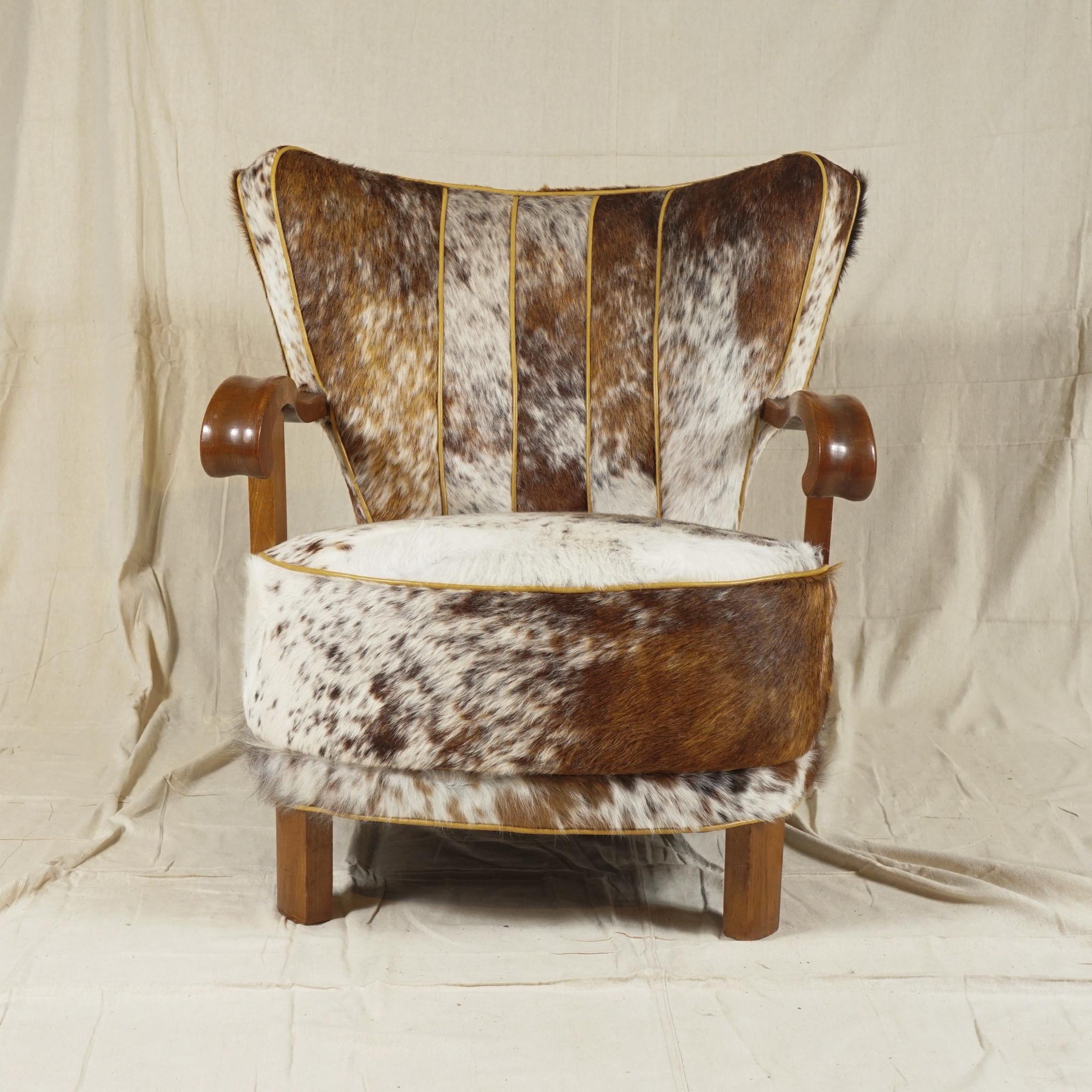 A sturdy, Danish modern easy armchair from 1940s recovered in patterned soft cowhide,
with strong, curved oak arms just in the right place and most comfortable to sit in. Great for study, library or living room.
  