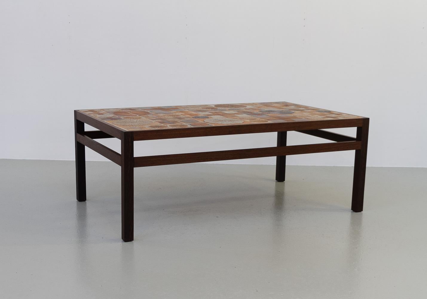 Danish Modern Tue Poulsen Tile Coffee Table in Wengé, 1960s.

Scandinavian Mid-Century Modern coffee table designed by artist and ceramist Tue Poulsen and furniture designer Erik Wørtz. Produced by Willy Beck in Denmark, 1960s.

This unique lounge