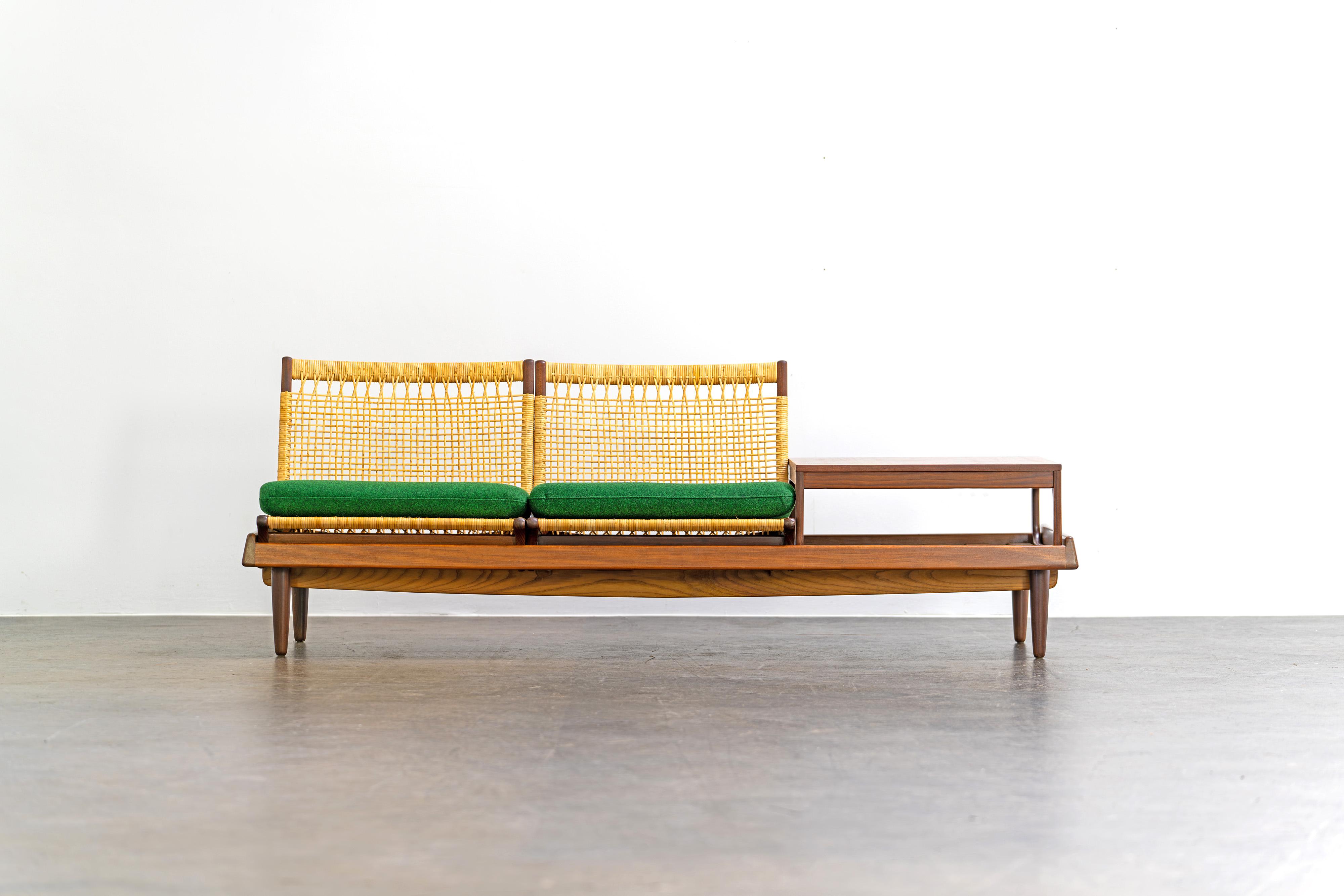 Modular teak TV bench model 161 by Hans Olsen for Bramin, Denmark. The set consists of a bench, two seating modules and a table. Four cushions are included. We have two full sets in stock that can be used as a corner combination.