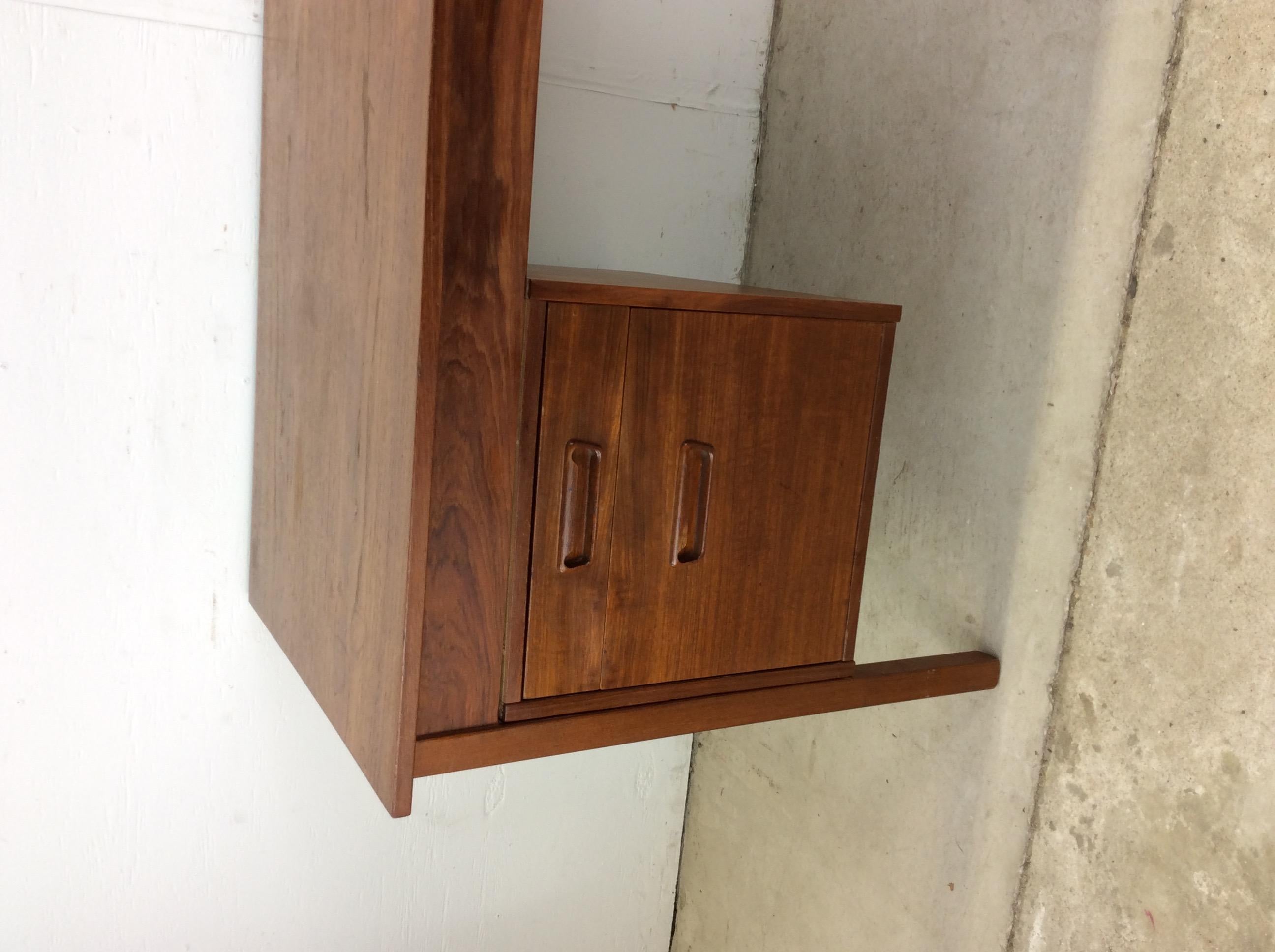 This danish modern writing desk features hard wood construction, original teak veneer, two drawers with carved wood pulls, drop leaf extending section, and tall tapered legs.

Dimensions: 45.5w 24d 28.5h 24.75kh  

Condition notes: Original teak