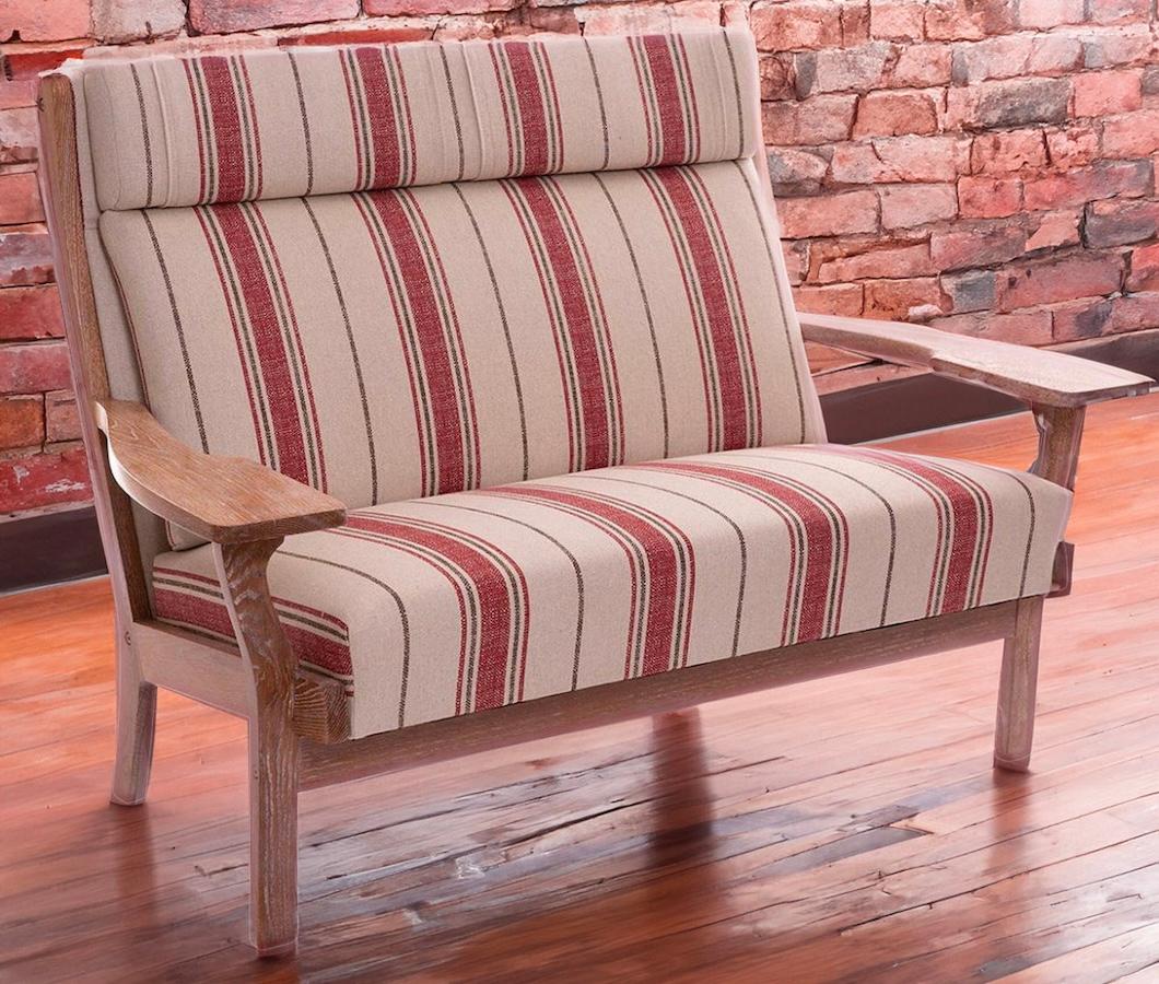 Danish modern striped two-seater designed by Hans J. Wegner for Getma, circa 1960s features a solid oak frame and is in good overall condition. Dimensions: 53.50