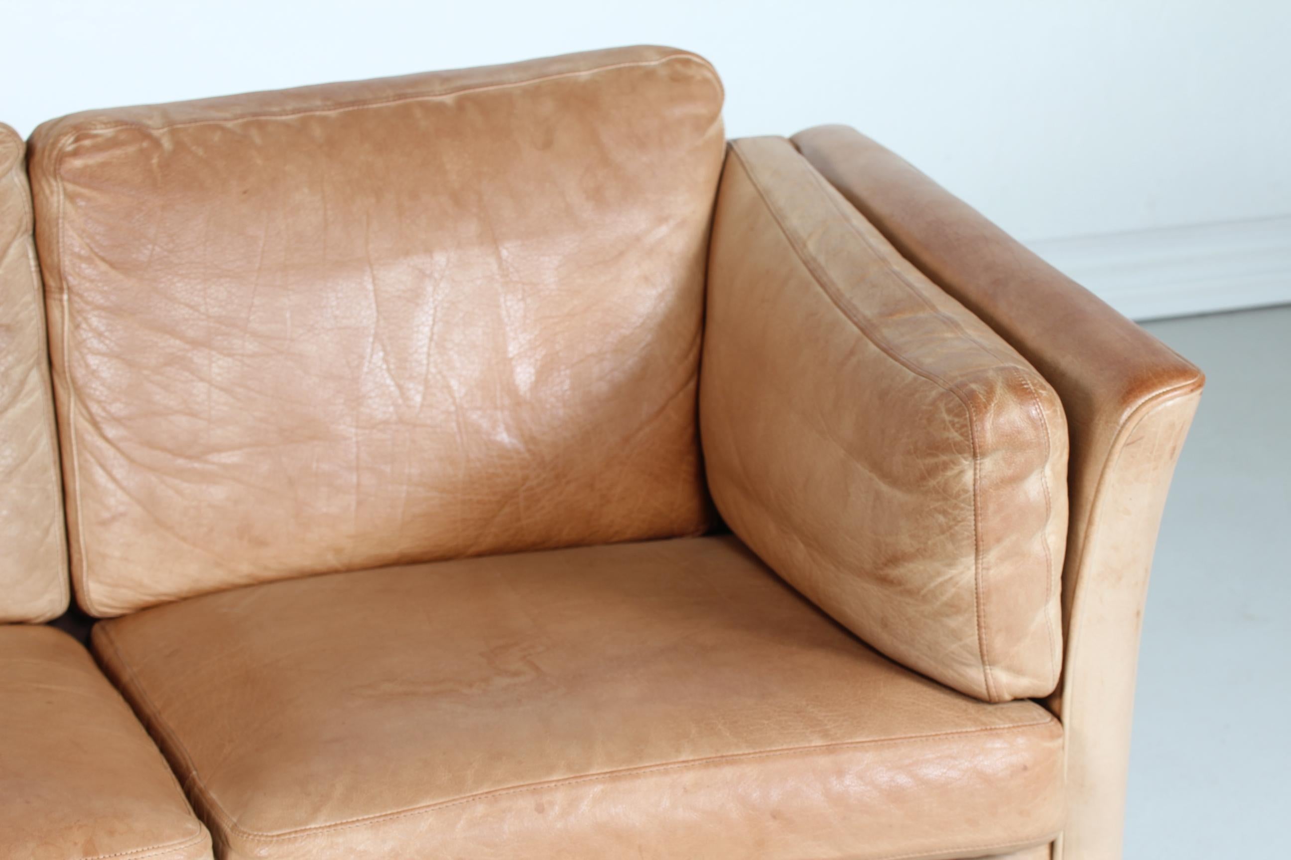 Danish vintage sofa for 2 persons manufactured in Denmark in the 1980s.
It's upholstered with the original cognac-colored leather which has got a good patina after use and age.

Nice vintage condition with patina - tiny spots and scratches may