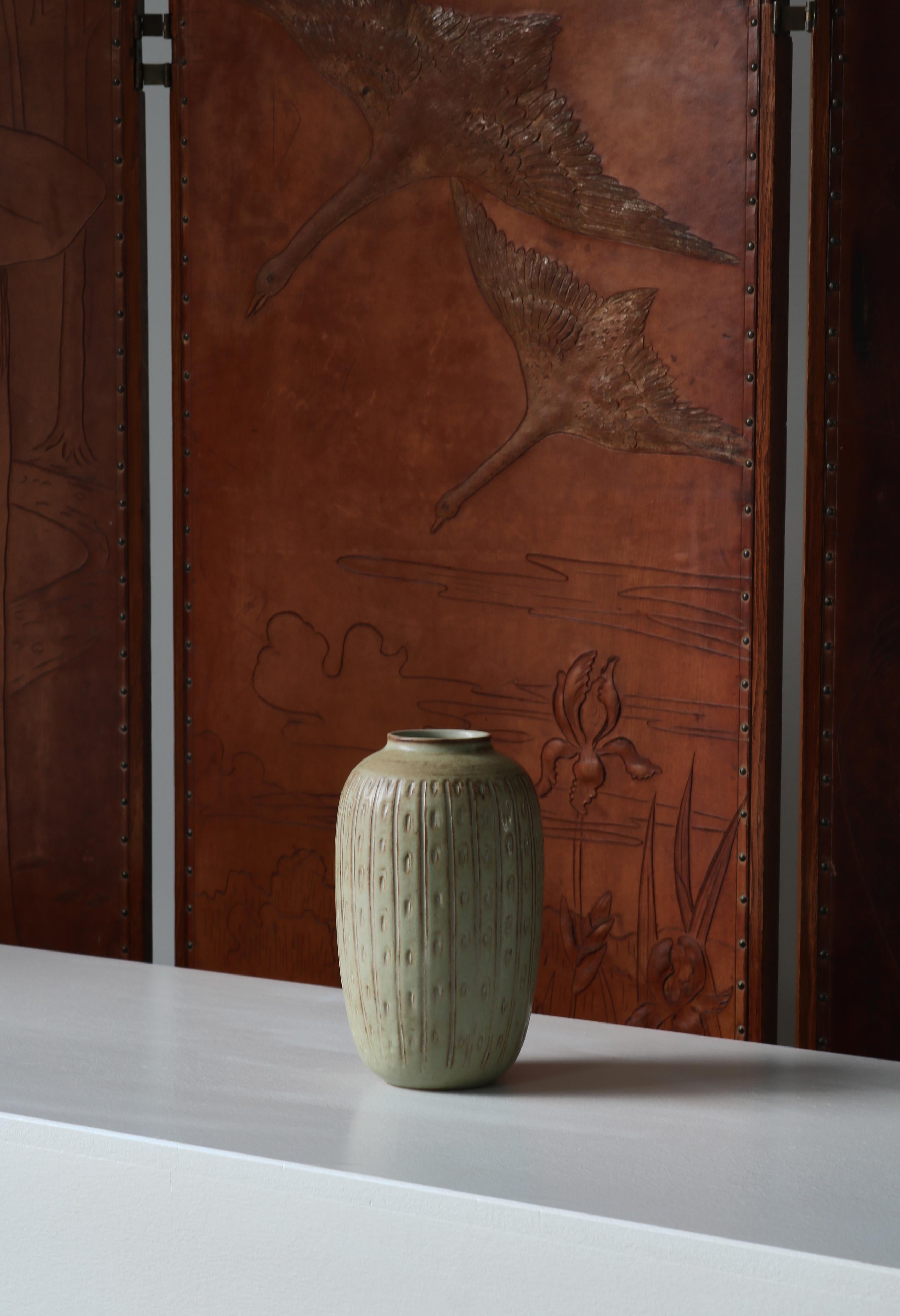 Beautiful unique stoneware vase handmade by female ceramic artist Gerd Bøgelund. Model no. 21743. Made at the workshop of Royal Copenhagen in 1960. Decorated in relief with a light glazing. Signed (artist initials 