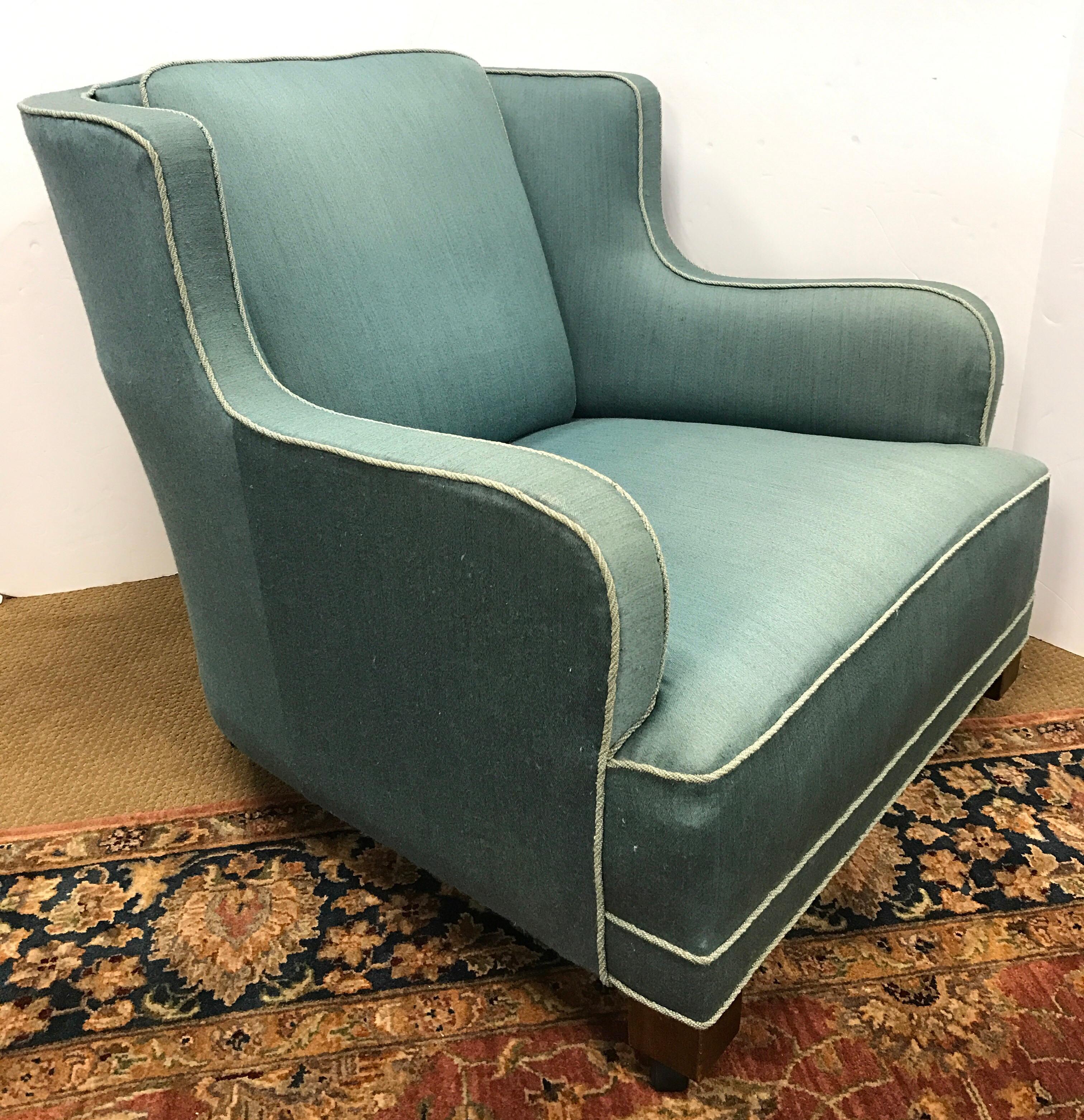 Stunning Danish modern, 1950s Danish aquamarine colored lounge chair. Upholstery is not original but is exquisite. Chairs legs at casters at bottom for ease of movement.