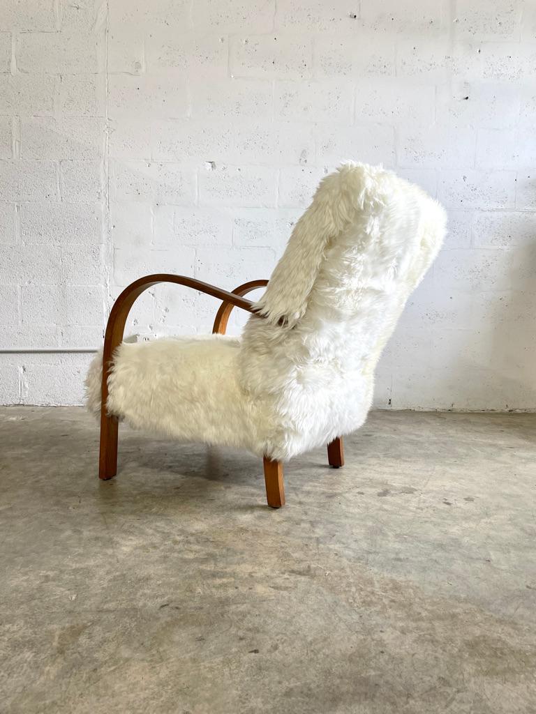 Danish Modern Vintage Lounge Chair in the style of Fritz Hansen. Imported from Denmark. Faux sheepskin. 