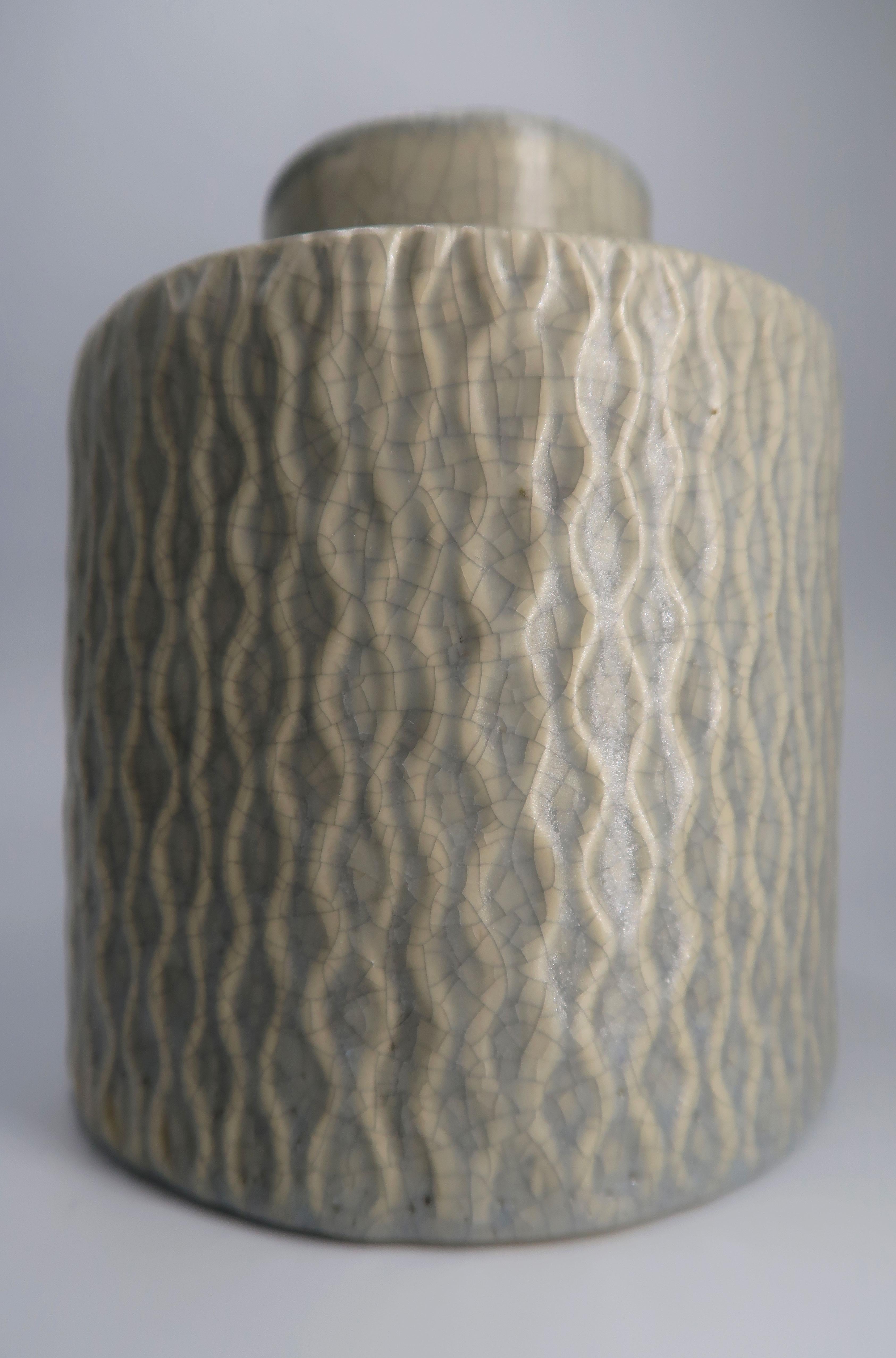 Danish mid-century modern handmade ceramic vase from the 1960s. Winding weave like pattern from top to bottom with sage green glaze outside and inside the vase. Crackle glaze with small imperfections adding to the vintage look of this piece. Fine