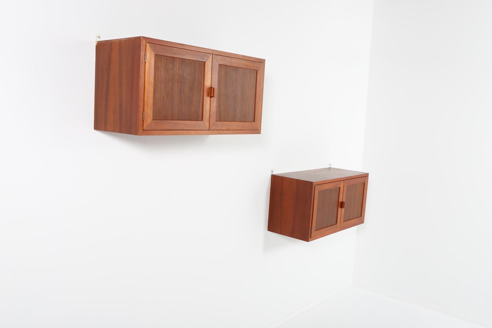 Beautiful pair varnished teak wall cabinets designed and produced in Denmark by Johannes Andersen.

Condition
Good, age related usage wear and marks

Dimensions
height: 40 cm
width: 80 cm
depth: 34 cm