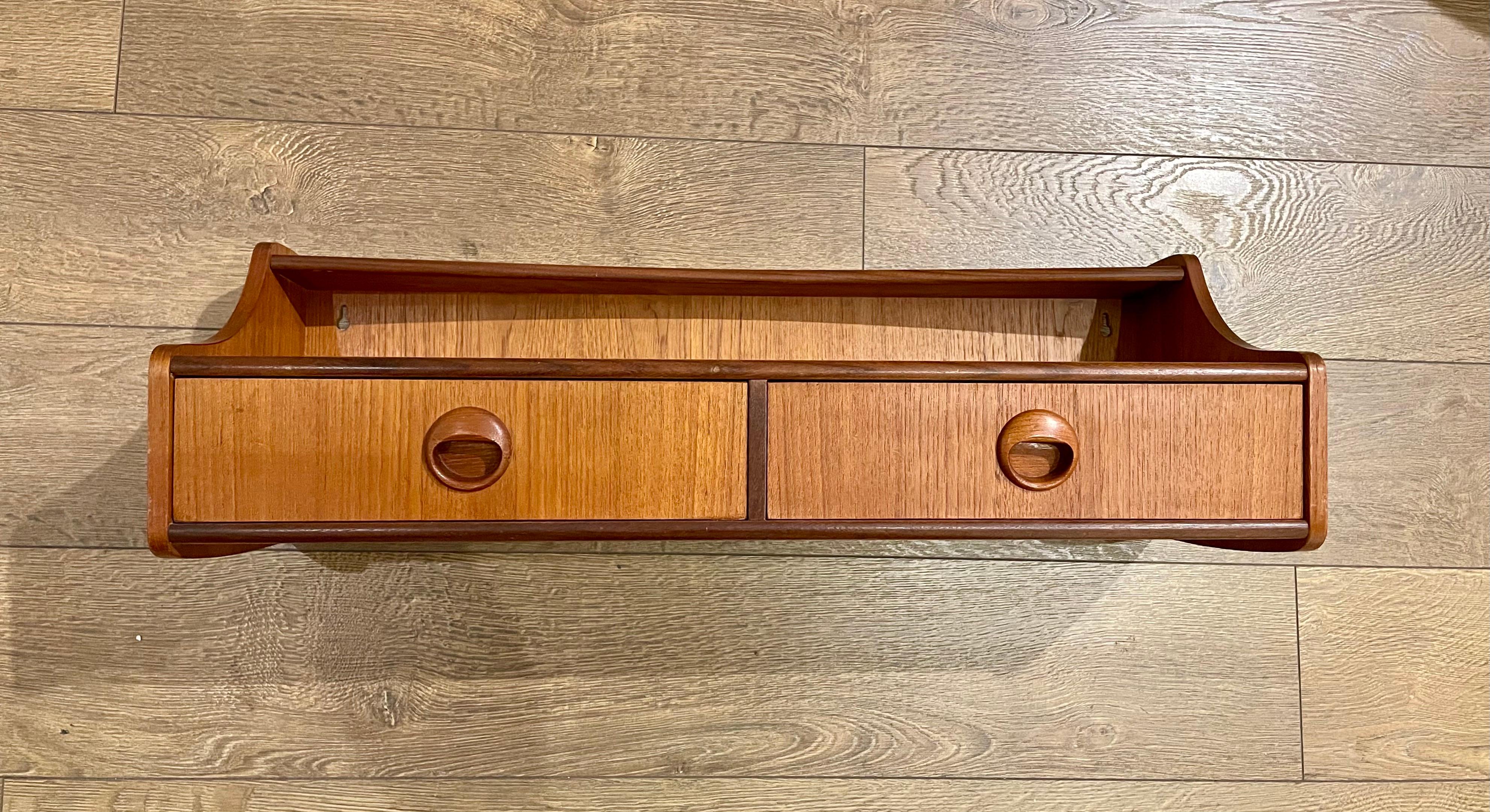 Versatile shelf double drawer wall mounted Danish modern teak entry table, design by TTalgo Mobler circa 1950's. Great craftsmanship dovetail drawers 2 screws hold it in place. Original finish nice clean condition we have oiled the piece.