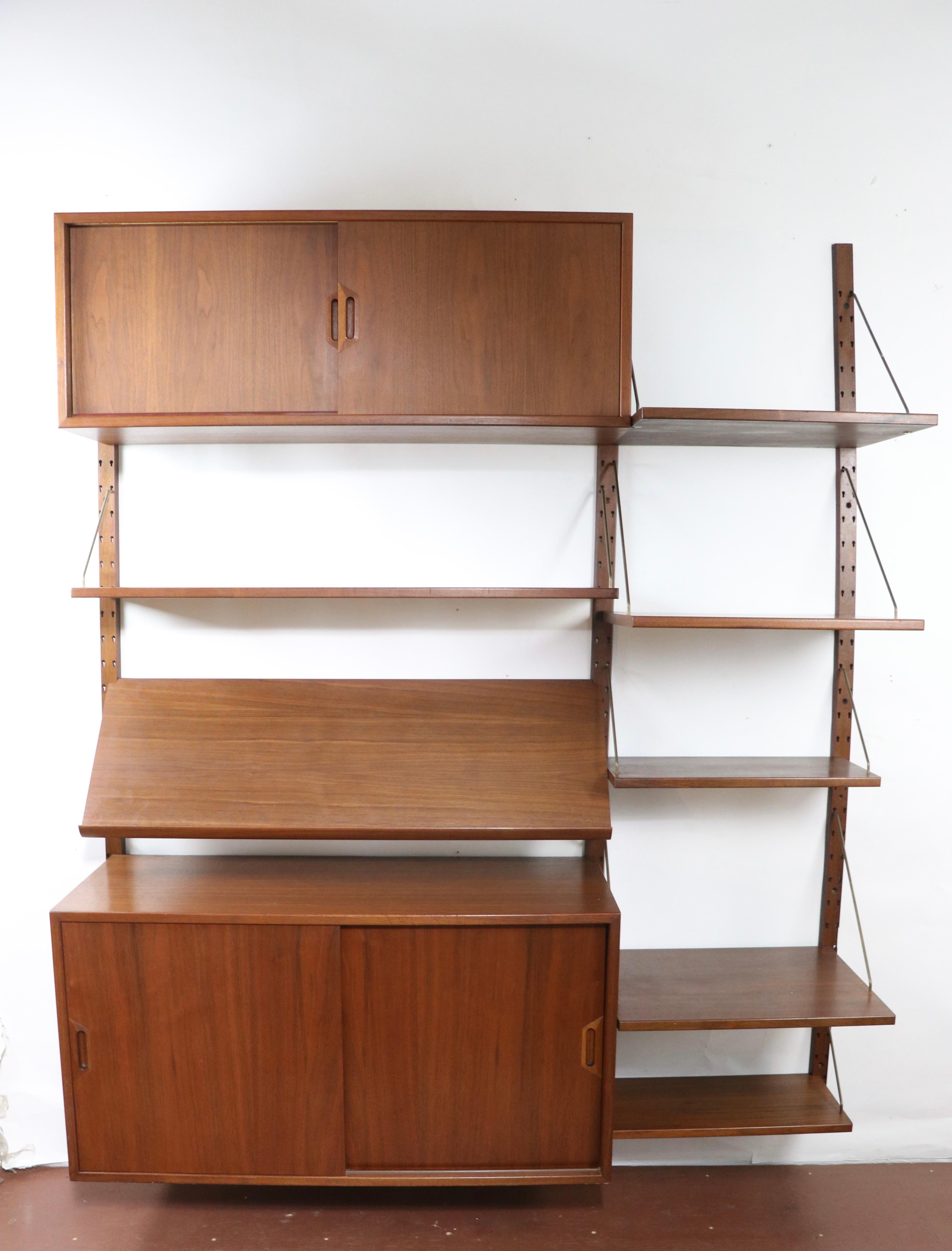 Nice Danish Modern wall unit designed by Sven Ellekjaer, imported by Raymor. This nice set features two storage cabinets, seven shelves, and three vertical supports. The elements are adjustable in position, allowing multiple configurations to suit