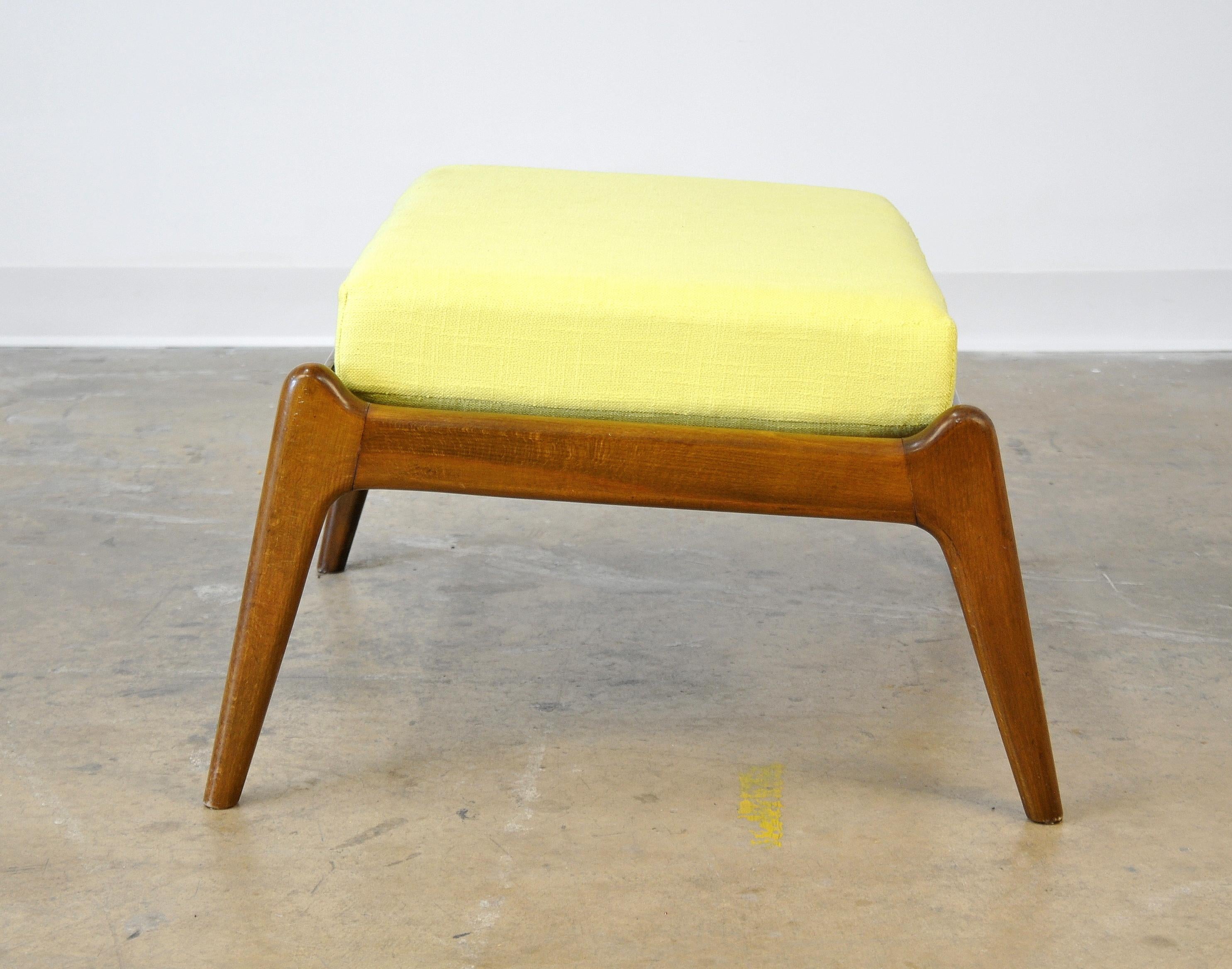 A vintage midcentury foot stool with a removable cushion, dating from the 1950s and attributed to designer Ib Kofod-Larsen. The footrest, inclined for best comfort, has a new cushion with bright sunshine yellow upholstery and great lines. Marked