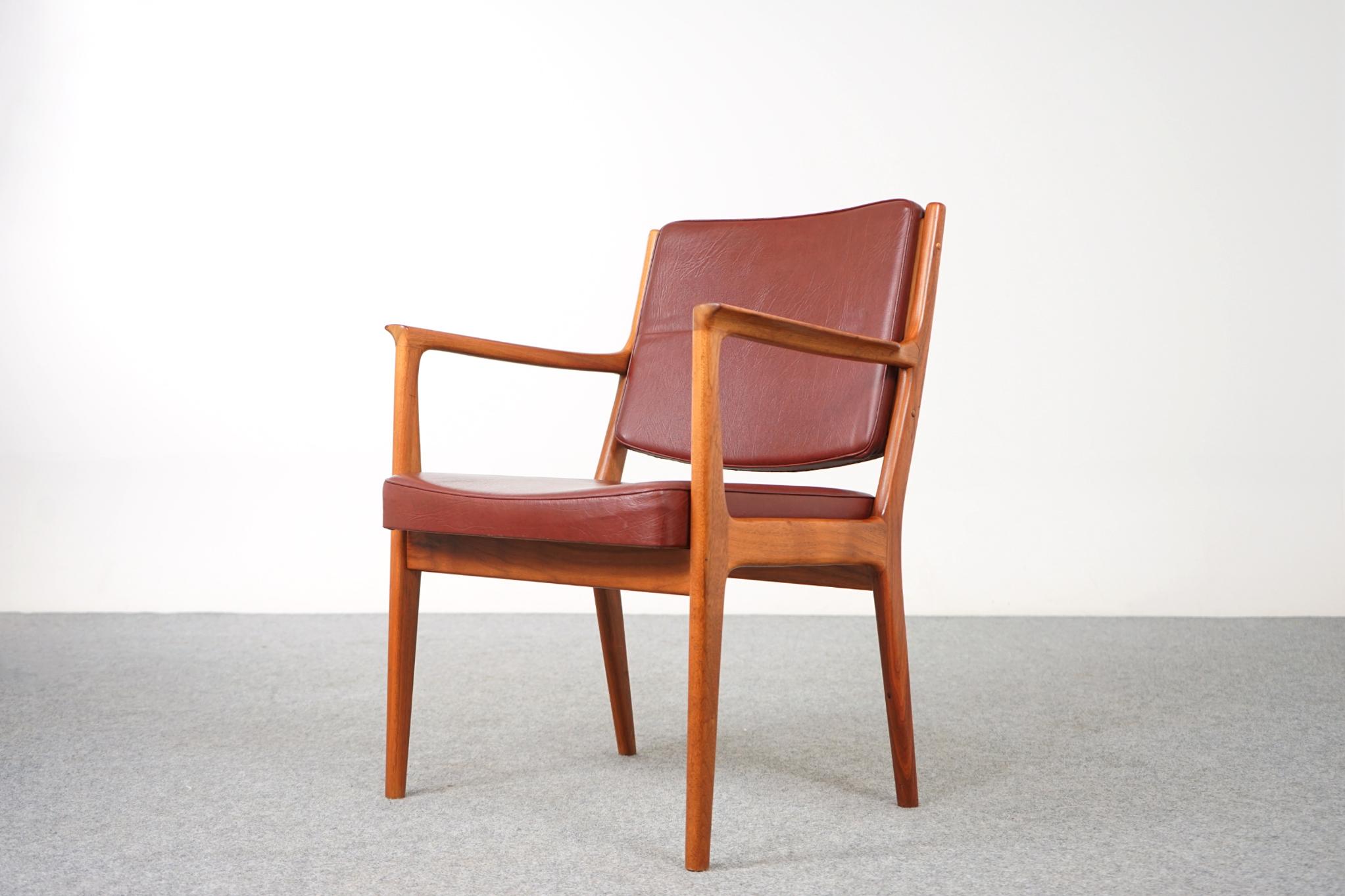 Walnut Danish armchair, circa 1970's. Sturdy solid wood frame is wonderfully scaled for your many seating needs, home or office! The elegant frame with swooping arms makes this clean modern design easy to combine with other furniture. 

Relax in