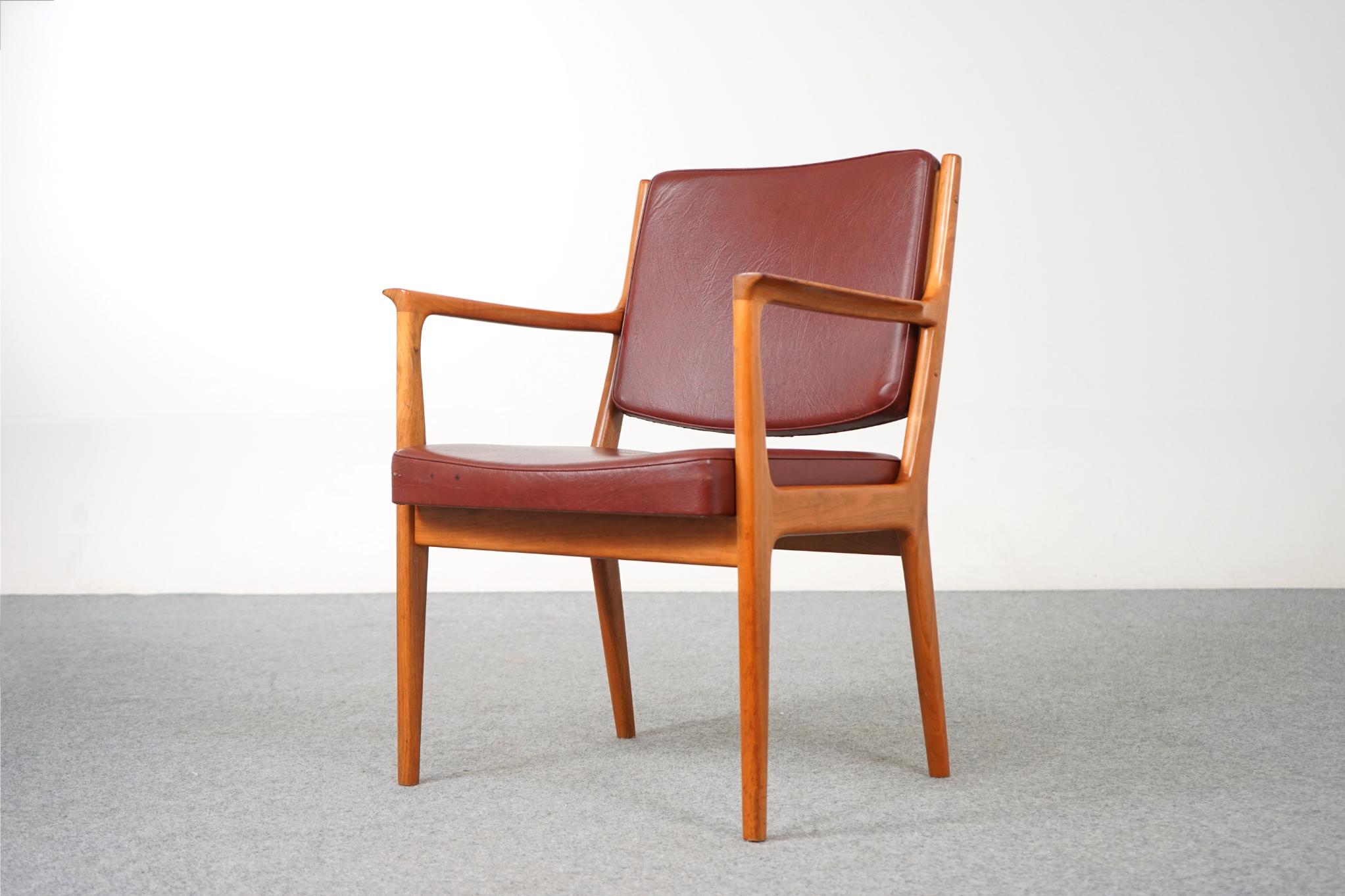 Walnut Danish armchair, circa 1970's. Sturdy solid wood frame is wonderfully scaled for your many seating needs, home or office! The elegant frame with swooping arms makes this clean modern design easy to combine with other furniture. 

Relax in