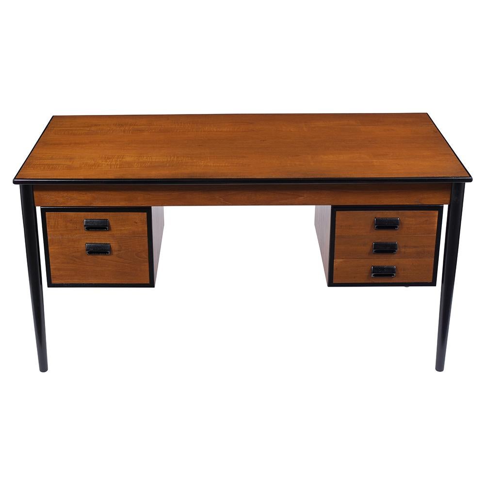 An extraordinary Mid-Century Modern style desk crafted from walnut wood has been professionally restored. This desk features a walnut color with ebonized accents details with a lacquered finish two floating cabinets with five drawers eye-catching