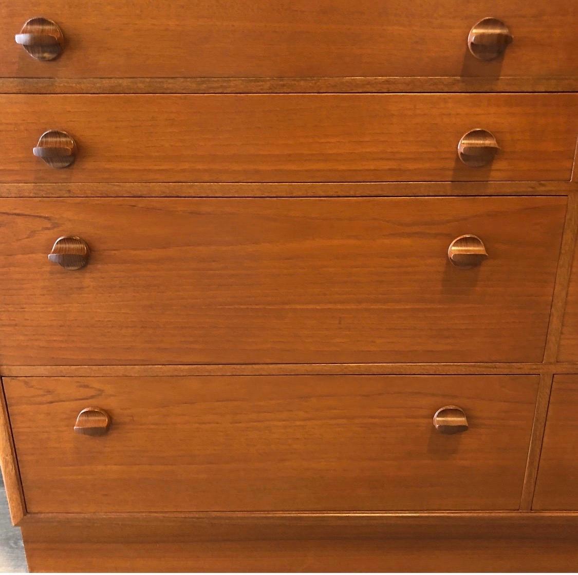 Elegant Danish modern walnut dresser that has been professionally polished. Look closely at the carved circular pulls and you'll get an idea of the craftsmanship. True period period piece from the 1970s. Ample storage and great scale.