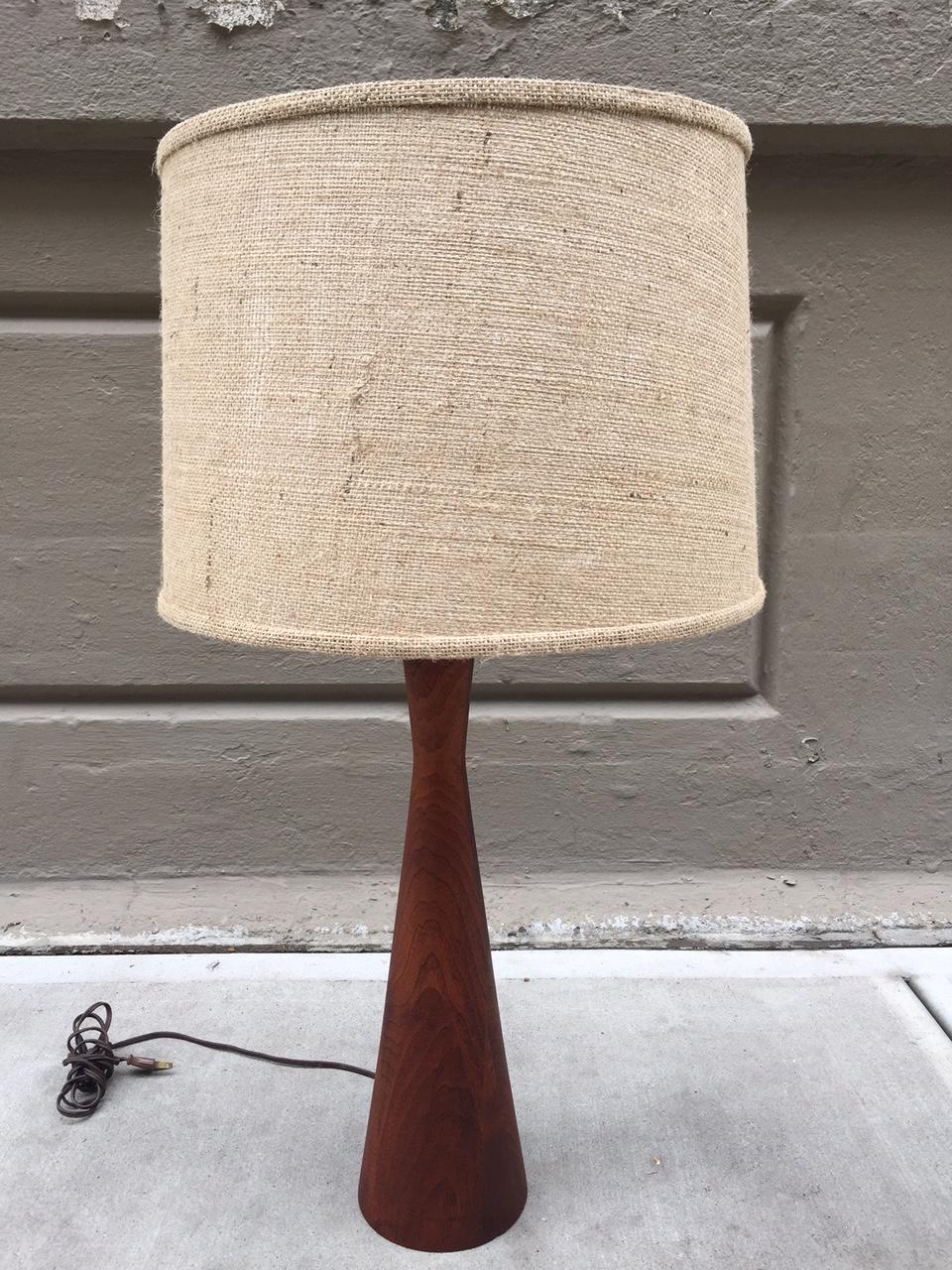Danish modern walnut lamp.
Measures:  31H (top of finial).  Base: 5.5 in diameter.
Shade not included.