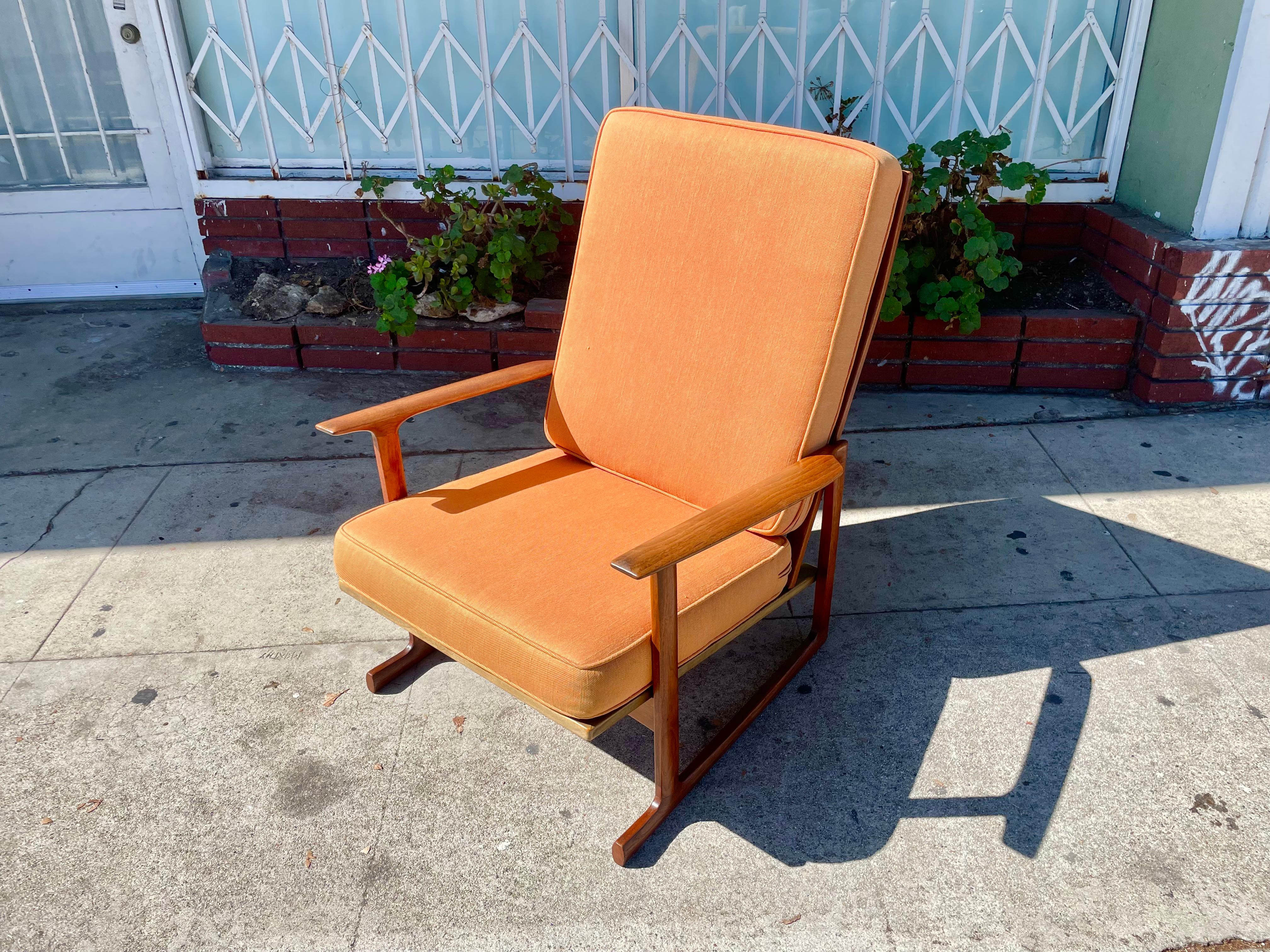 Danish modern walnut high back lounge chair designed by Ib Kofod Larsen and manufactured by Selig in Denmark circa 1960s. This beautiful highback lounge chair features a solid walnut frame with an excellent color tone and a beautiful grain pattern