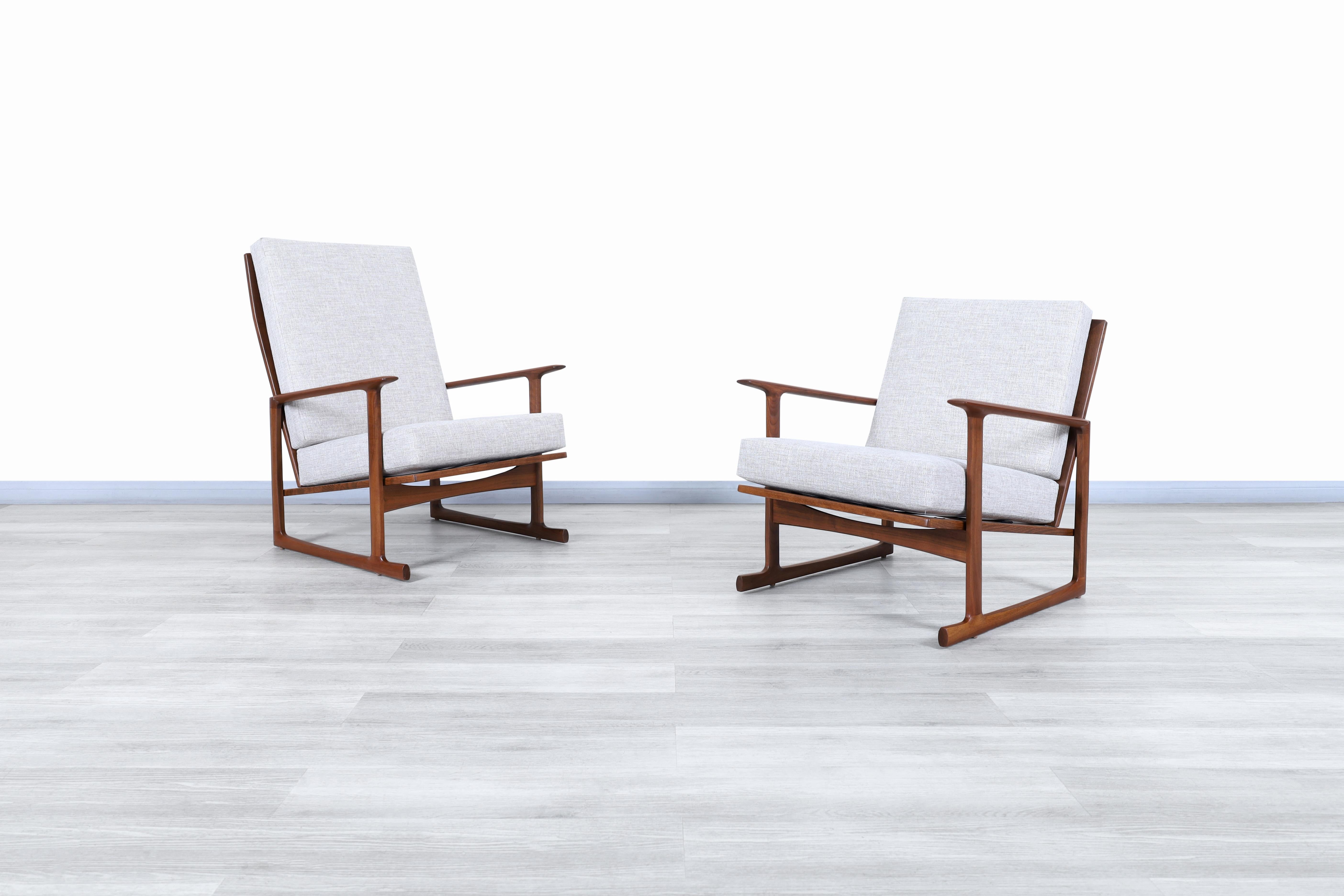 Wonderful Danish modern walnut lounge chairs by architect and furniture designer Ib Kofod for Selig in Denmark, circa 1960s. These chairs have an architectural design that focuses on user comfort and is complemented by the elegance of its