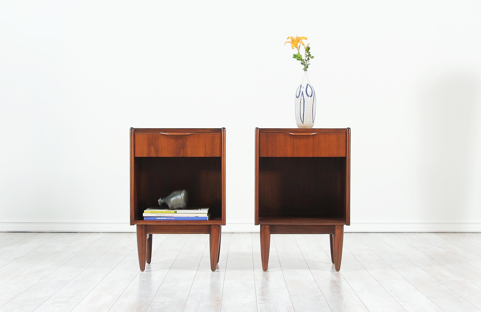 Exceptional pair of Danish modern night stands designed and manufactured in Denmark, circa 1950s. These gorgeous night stands are newly refinished by our expert craftsmen to feature a sturdy and sleek design offering ample storage. Each nightstand