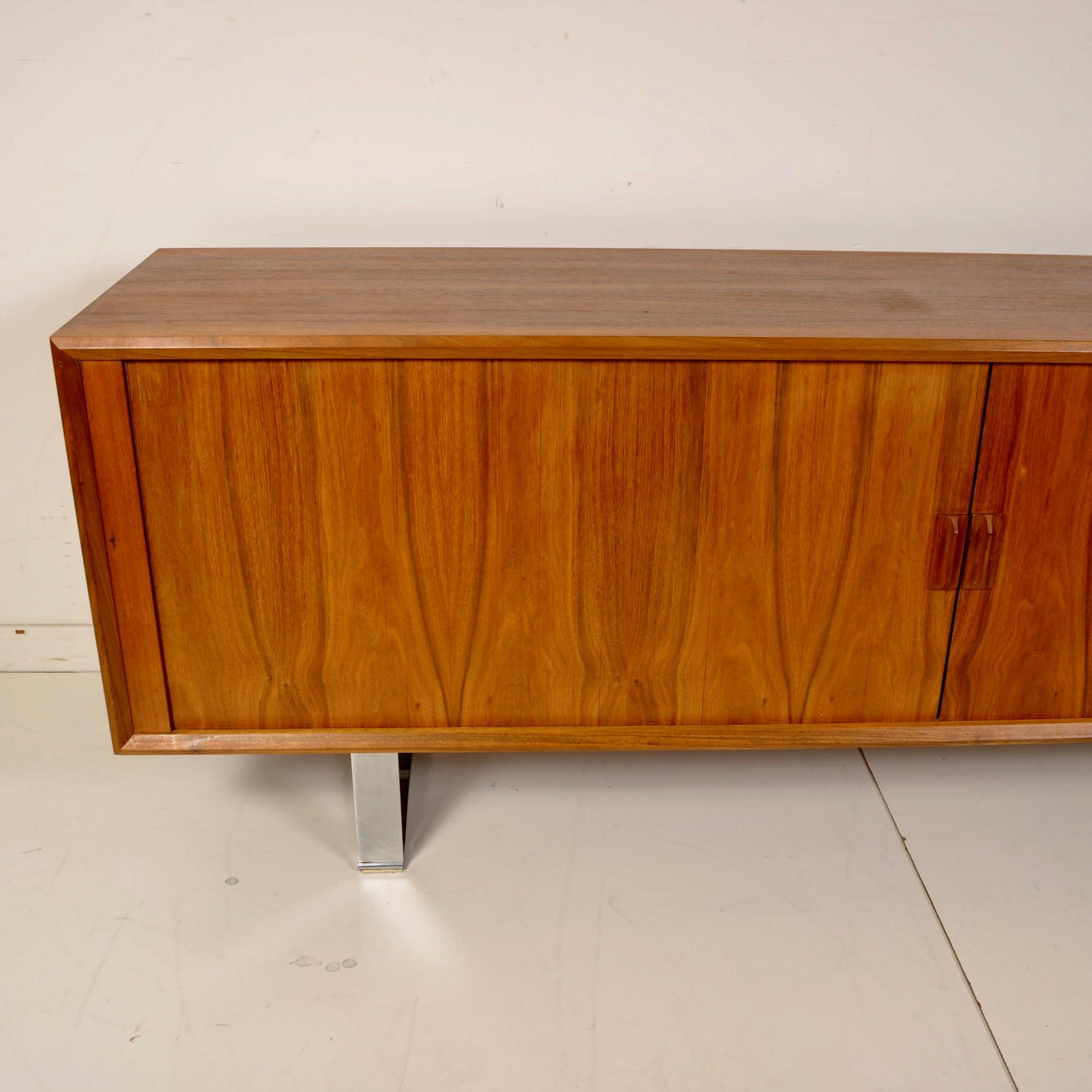 Clean walnut, tambour doored sideboard made in Canada in the 1970s. Finished on all sides and resting on chrome pedestals, this would make a great piece to act as a room divider.
